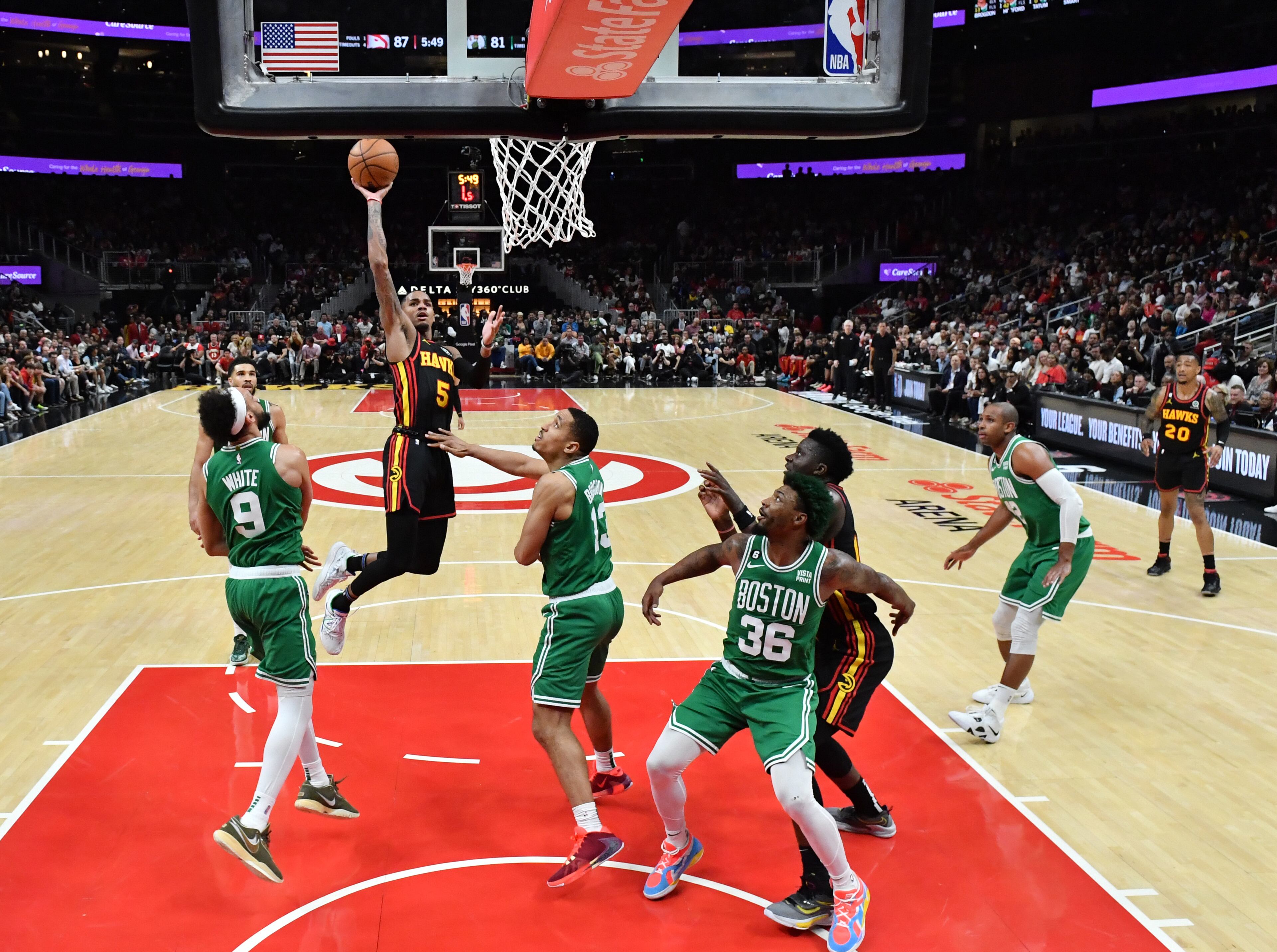 Atlanta Hawks' guard Dejounte Murray (5) goes up for the shot over Boston Celtics' guard Derrick White (9) and guard Malcolm Brogdon (13) during the second half in Game 3. (Hyosub Shin / Hyosub.Shin@ajc.com)