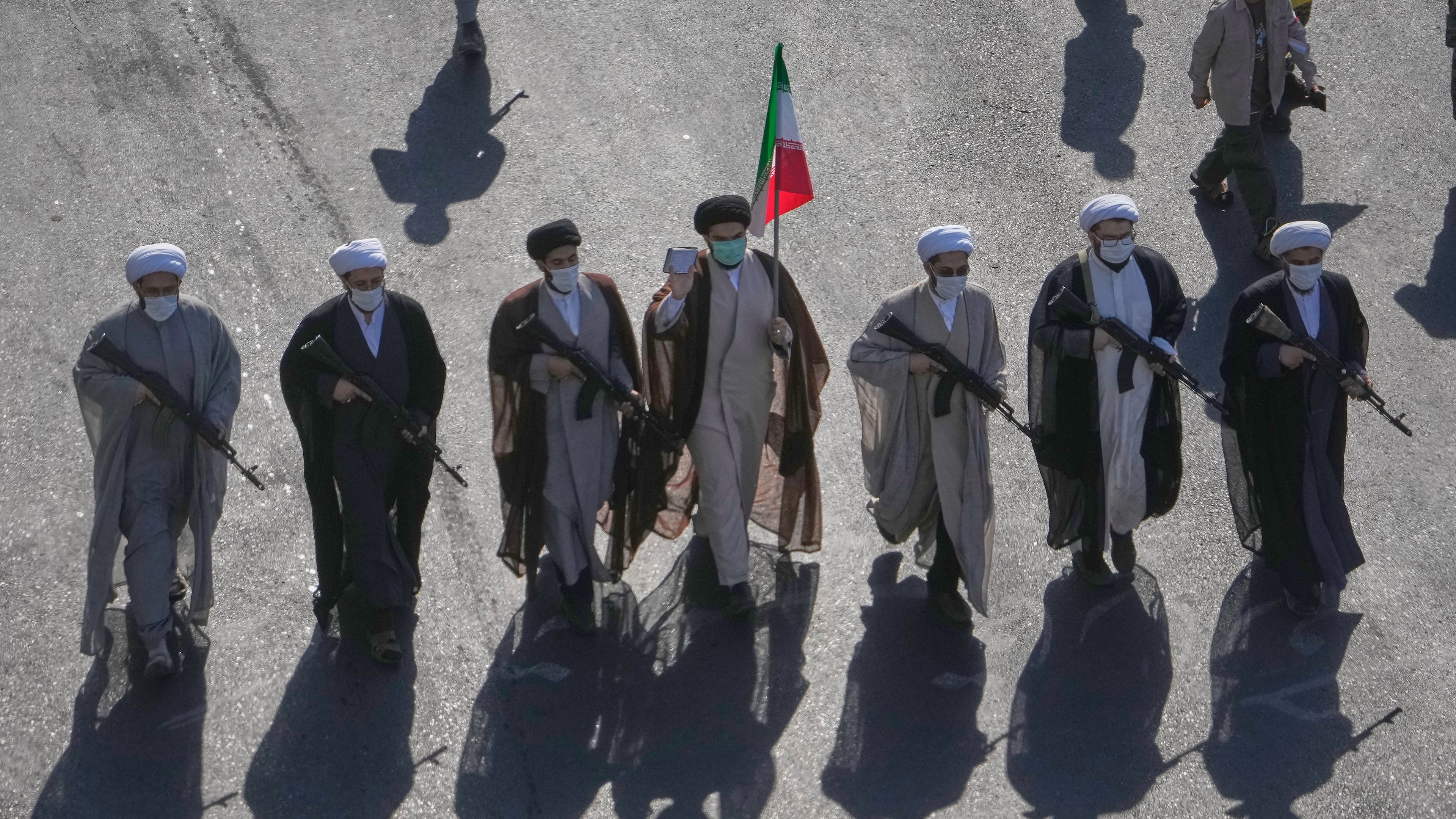Shiite clerics carrying rifles march during the state-organized "Janfada," or "Sacrifice for Iran," military-style parade at Revolution Square in Tehran, Iran, Friday, Sept. 18, 2026. (AP Photo/Vahid Salemi)