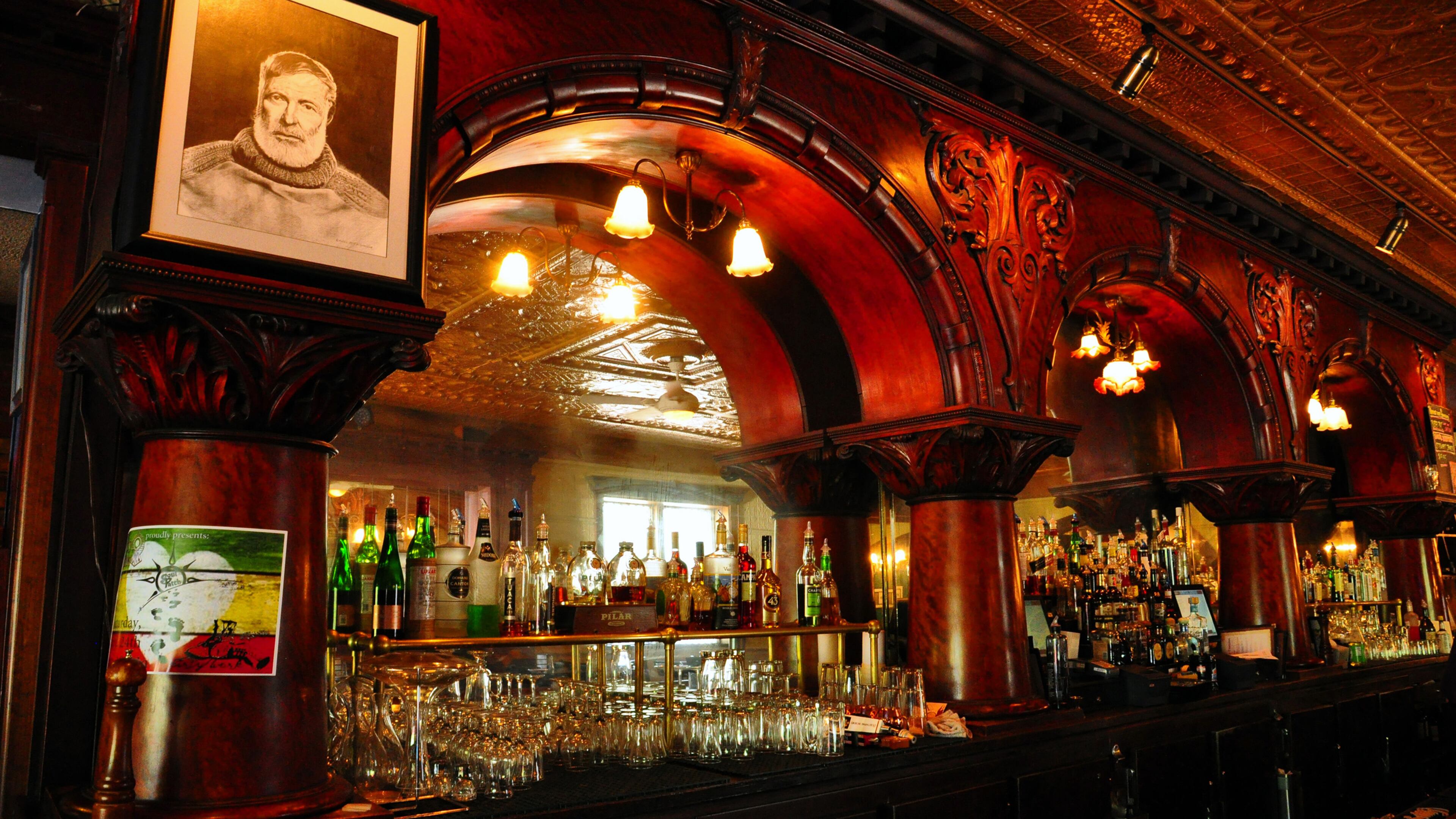 A portrait of Ernest Hemingway looks down from the mahogany bar at City Park Grill in Petoskey, Mich. (Katherine Rodeghier/Chicago Tribune/TNS)