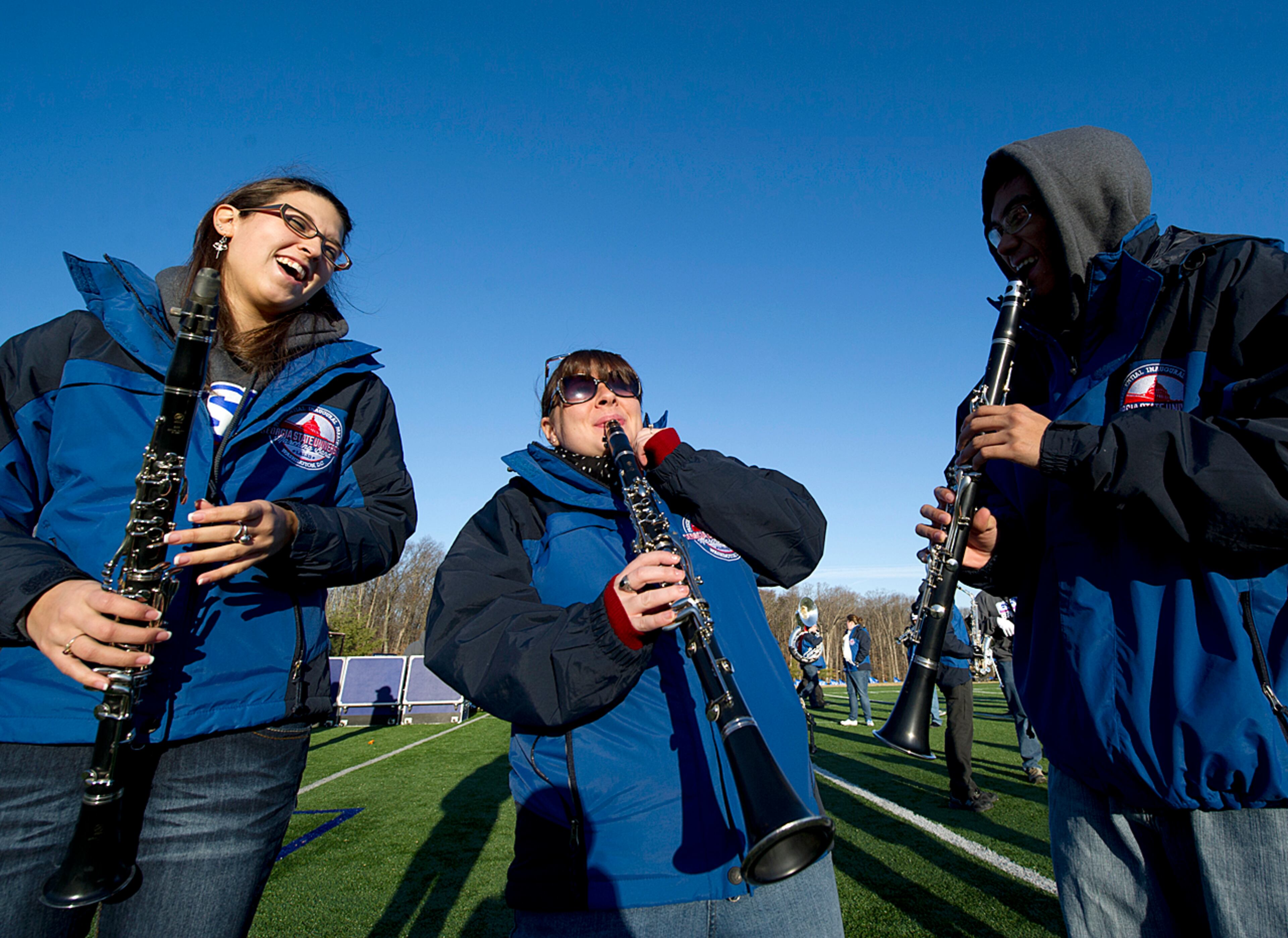 Regan Wes (left), Cassie Trout, and AJ Lonzanida playing clarinet during music rehearsal as GSU Marching Band practices for the last time at Flint Hill School in Fairfax, VA.