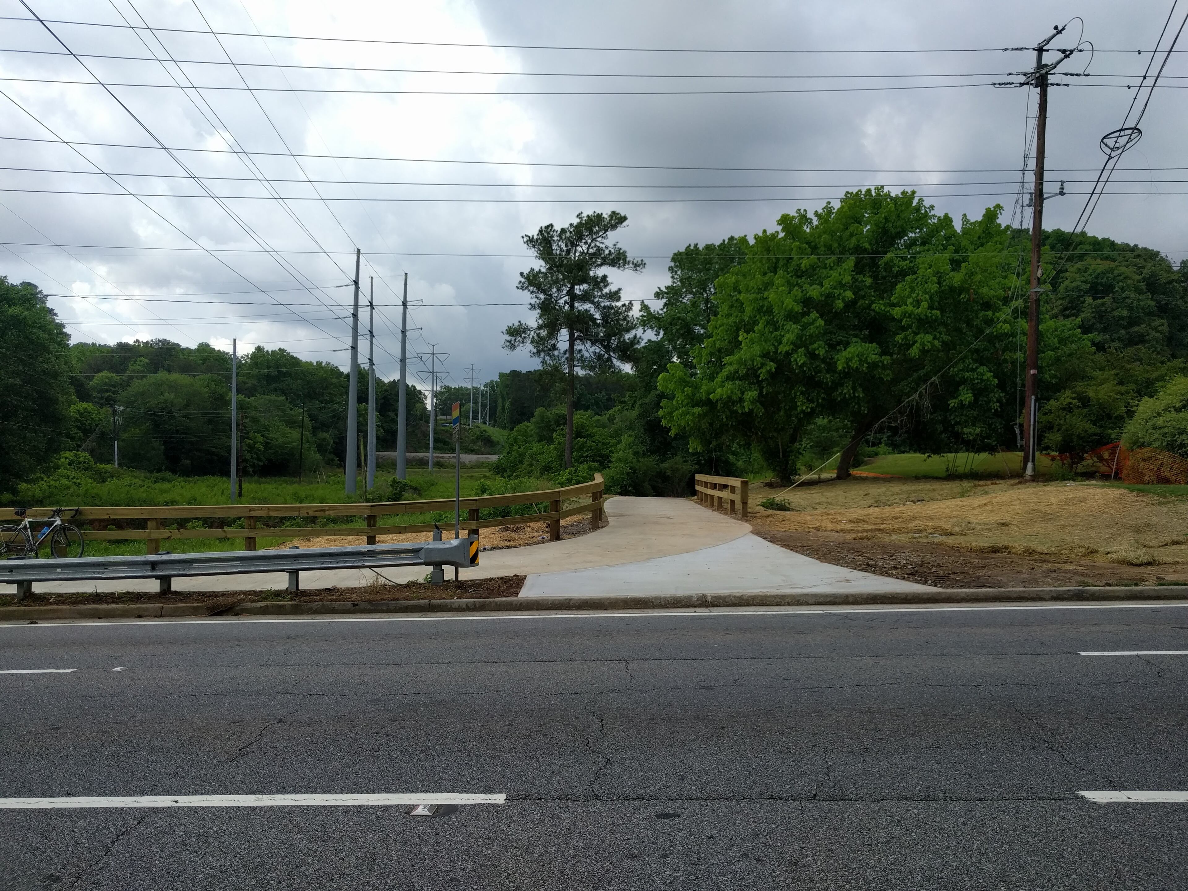 The new extension of South Peachtree Creek Trail connects to a crosswalk on North Druid Hills Road, and the residential areas to the north.
