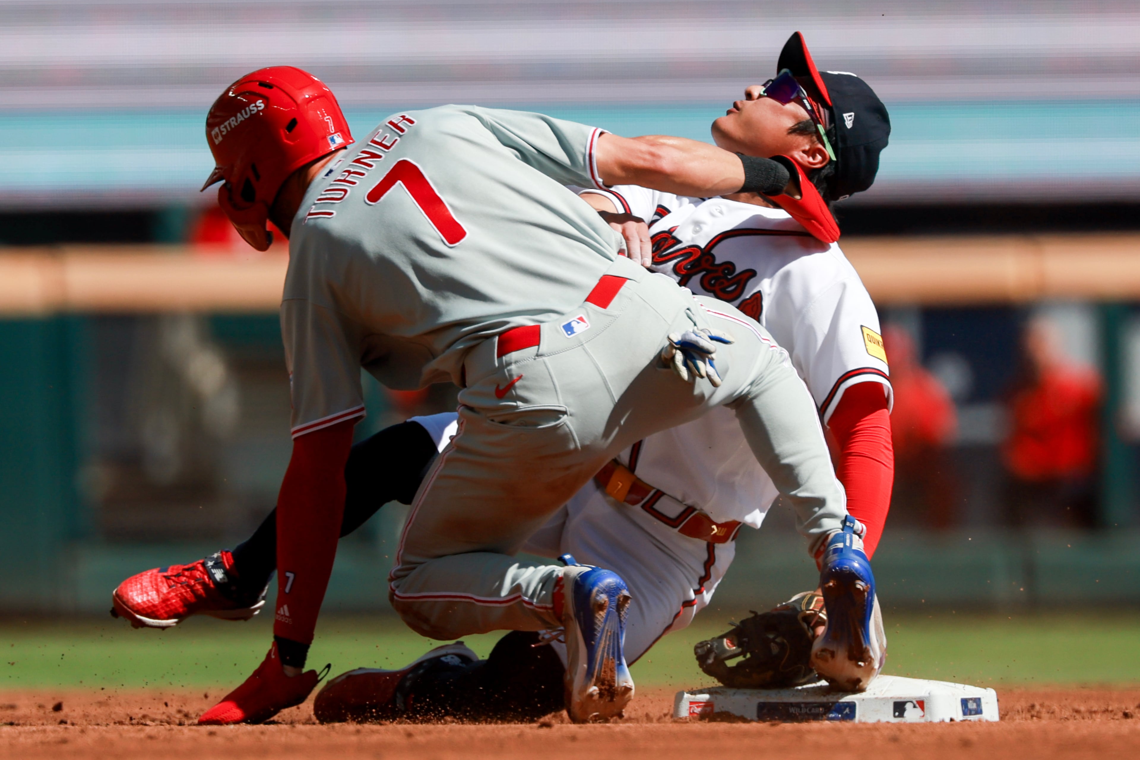 Philadelphia Phillies shortstop Trea Turner (7) collides with Atlanta Braves shortstop Ha-Seong Kim while getting tagged out on a steal attempt at second base during the third inning of Game 1 of a MLB National League Wild Card playoff series between the Atlanta Braves and the Philadelphia Phillies, Tuesday, Sept. 29, 2026, in Atlanta. (Jason Getz/AJC)