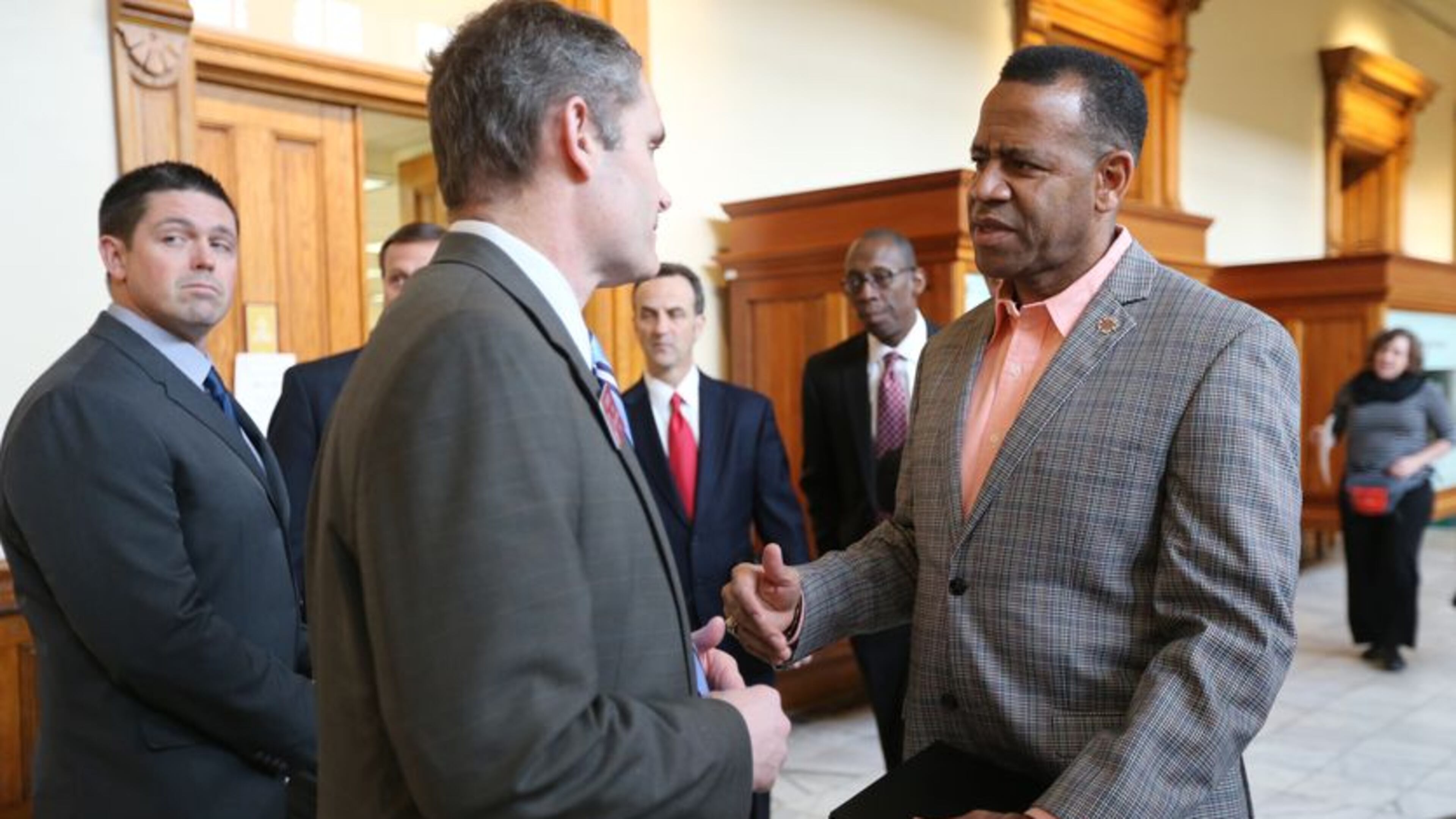 Former Atlanta fire chief Kelvin Cochran, right, greets state Rep. Ed Setzler, R-Acworth, before a press conference announcing his federal lawsuit against the city of Atlanta. Ben Gray, bgray@ajc.com