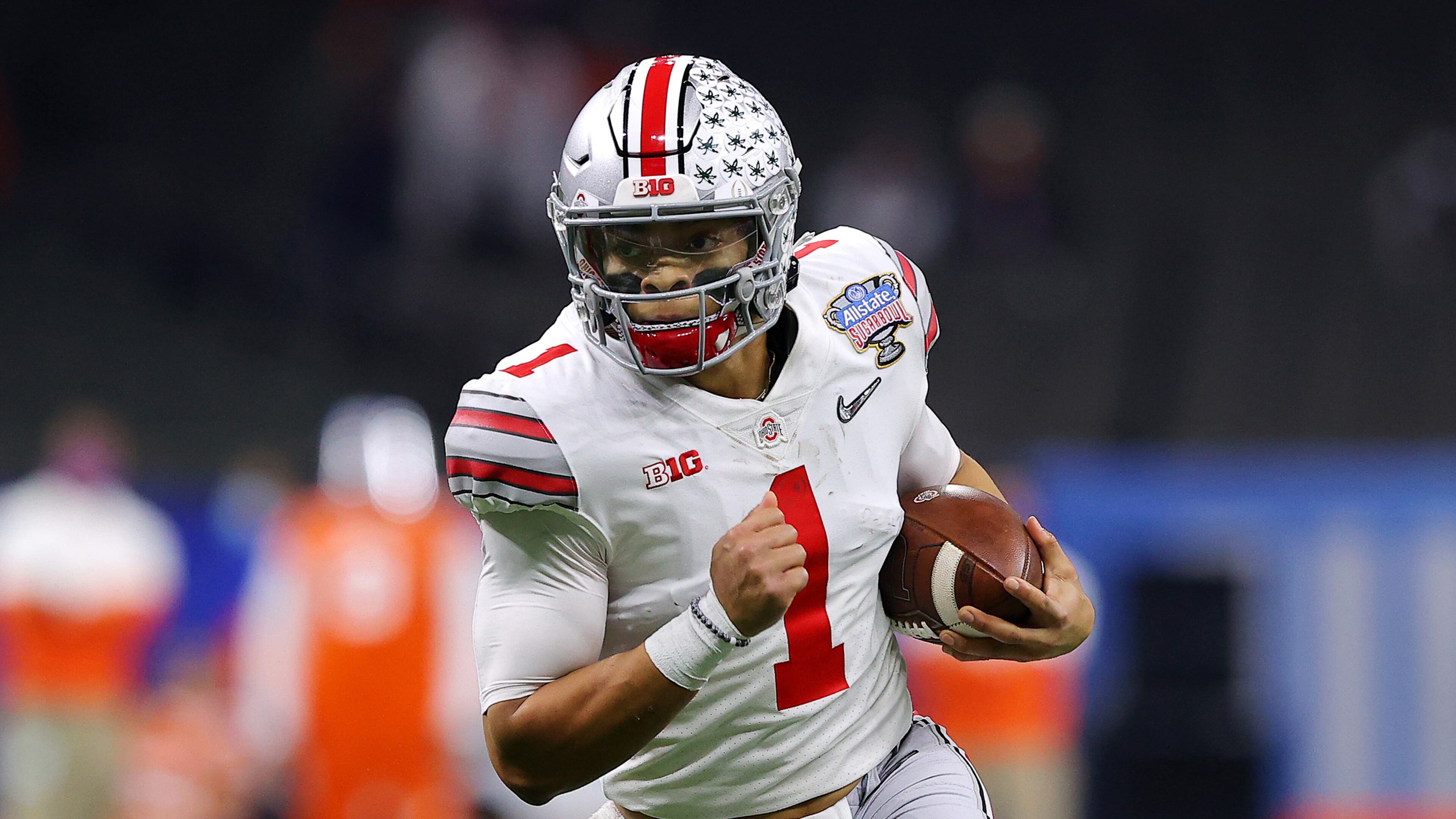 Justin Fields (1) of the Ohio State Buckeyes runs with the ball in the first half against the Clemson Tigers during the College Football Playoff semifinal game at the Allstate Sugar Bowl at Mercedes-Benz Superdome on Jan. 1, 2021 in New Orleans, Louisiana. (Kevin C. Cox/Getty Images/TNS)