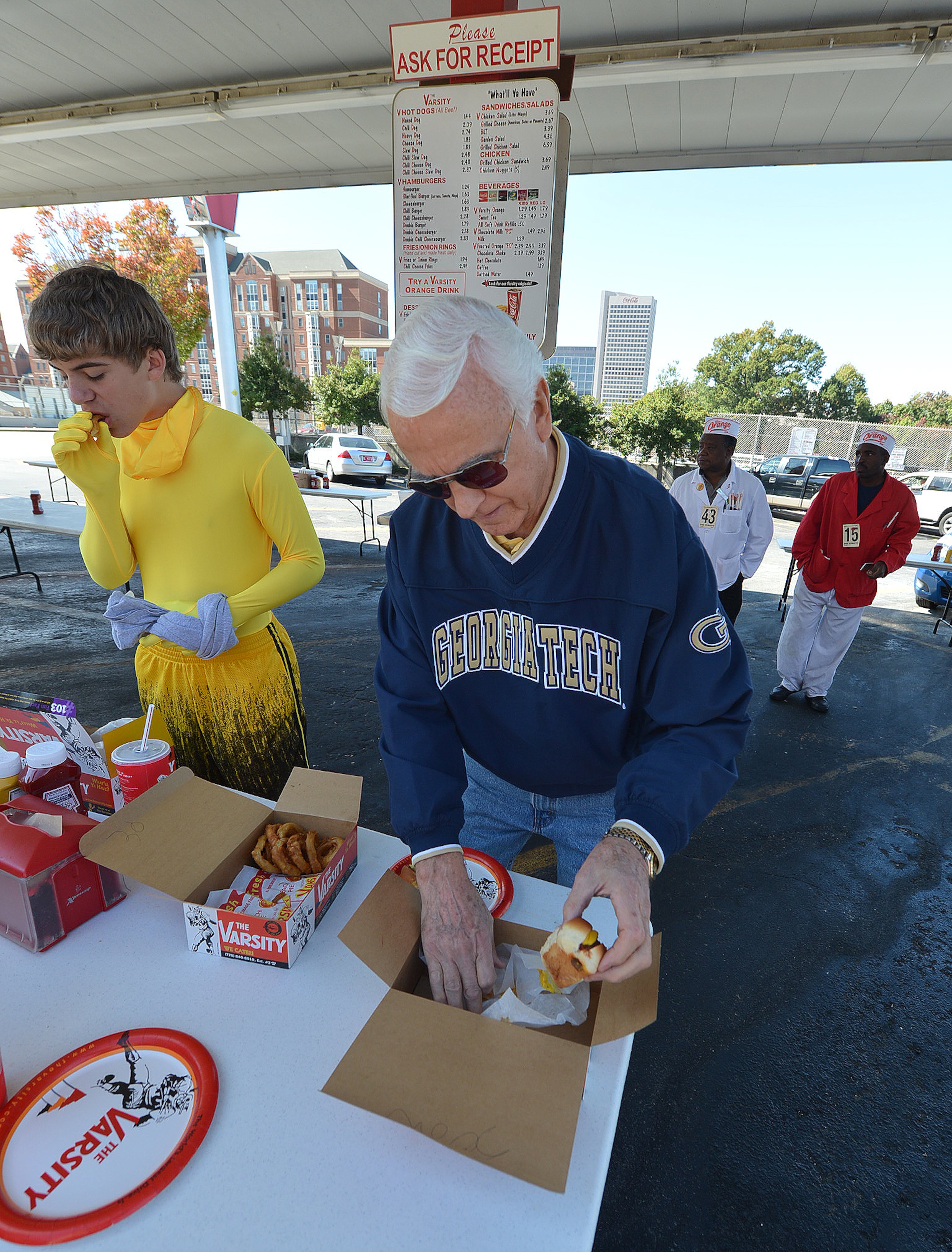 LEDE PHOTO!!! !October 20, 2012 - Atlanta, GA: Georgia Tech fan Bob Sexton picks up one of his chili cheese dogs outside of The Varsity on Saturday, October 20, 2012. On Saturdays, thousands of Georgia Tech fans eat at the landmark before and after the game. The Varsity is the busiest fast food restaurant in the city. JOHNNY CRAWFORD /JCRAWFORD@AJC.COM
