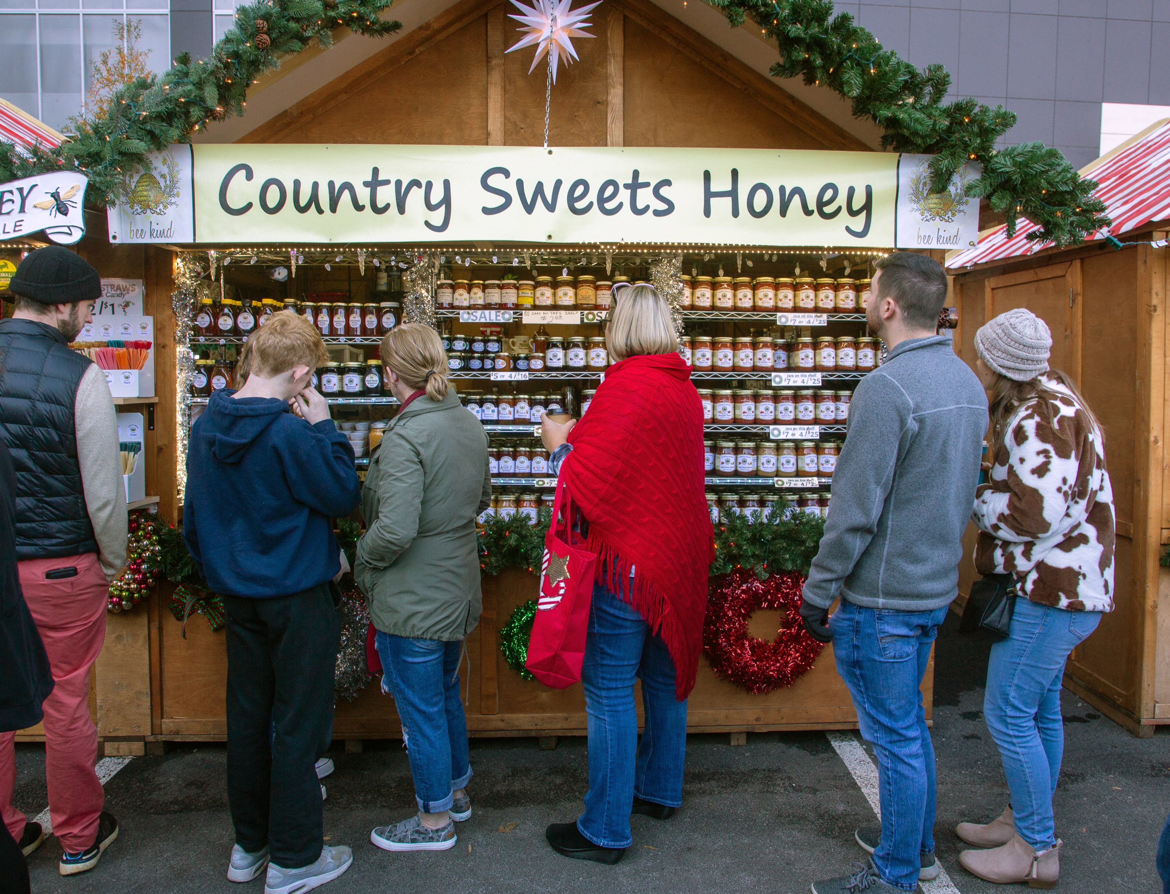 People look over a selection of honey while at the Atlanta Christkindl Market on Sunday, December 12, 2021.
STEVE SCHAEFER FOR THE ATLANTA JOURNAL-CONSTITUTION