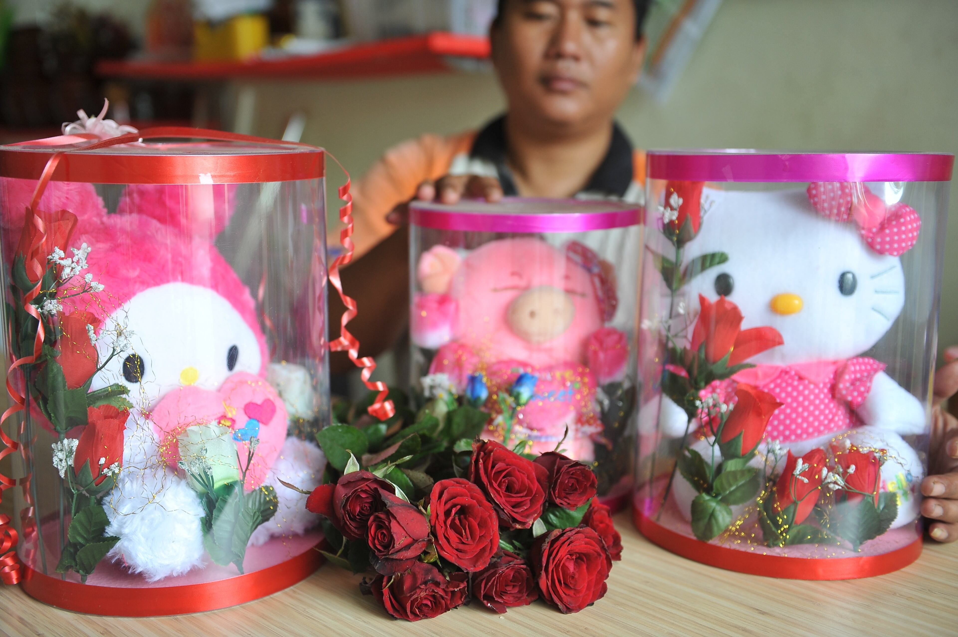 SURABAYA, INDONESIA - FEBRUARY 10: A vendor sets up Hello Kitty's toys on February 10, 2014 in Surabaya, Indonesia. Roses, chocolates, teddy bears, toy hearts, candles, and cards are all part of the preparations for the Valentines Day and orders increase significantly in the weeks leading up to the Valentines Day that will be celebrated on February 14th. (Photo by Robertus Pudyanto/Getty Images)