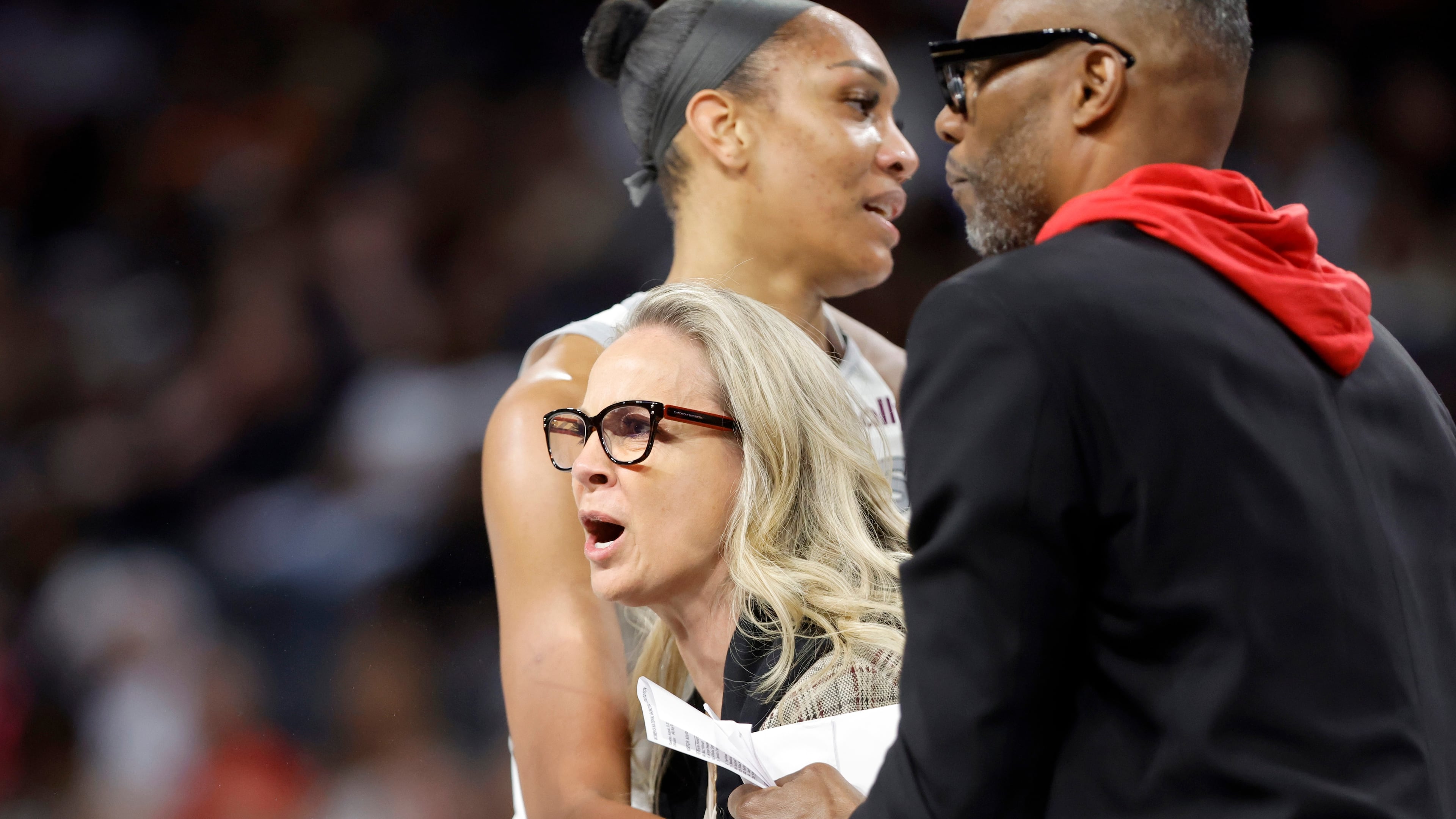 Las Vegas Aces head coach Becky Hammon is held back by Las Vegas Aces center A'ja Wilson and assistant coach Larry Lewis after being ejected during the first half of a WNBA basketball game between the Las Vegas Aces and the Atlanta Dream Tuesday, Aug. 18, 2026, in Las Vegas. (Steve Marcus/Las Vegas Sun via AP) CORRECTION: assistant coach Larry Lewis is correct instead of Tyrone Ellis