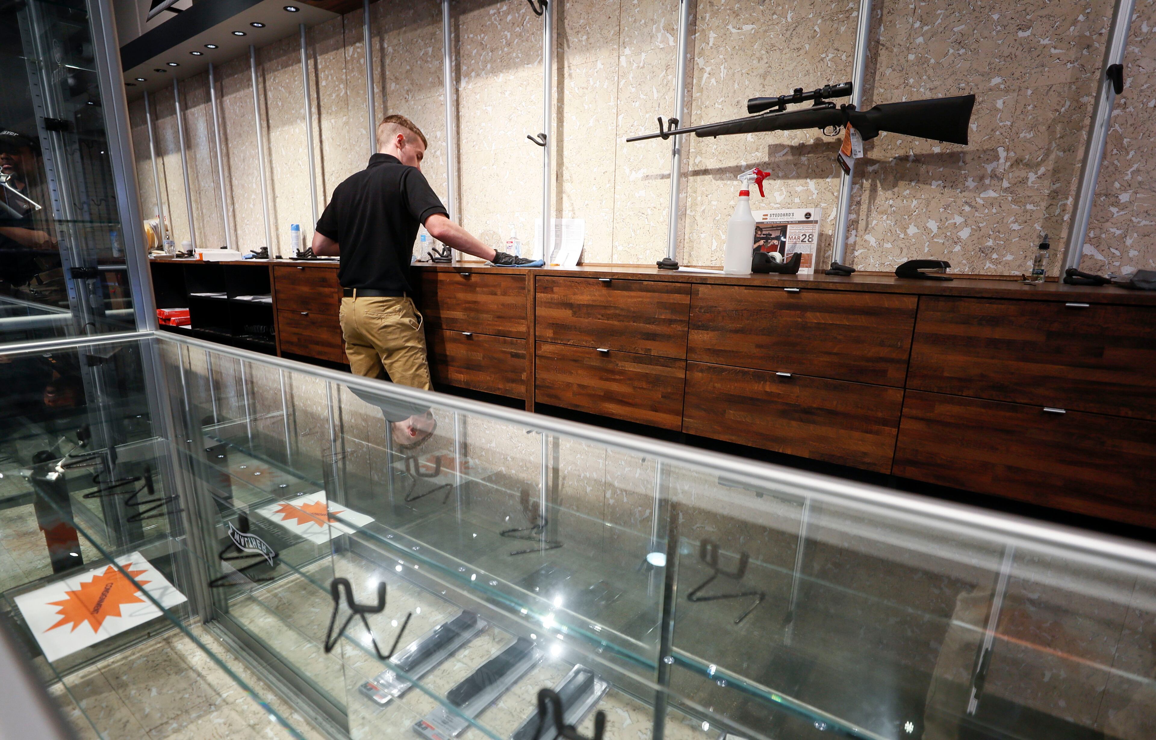 March 17, 2020 - Atlanta - An employee cleans counters at a nearly empty display at Stoddard's Range and Guns, in Atlanta, where the store has seen an uptick in ammunition and gun sales as the coronavirus threat intensifies. Bob Andres / robert.andres@ajc.com