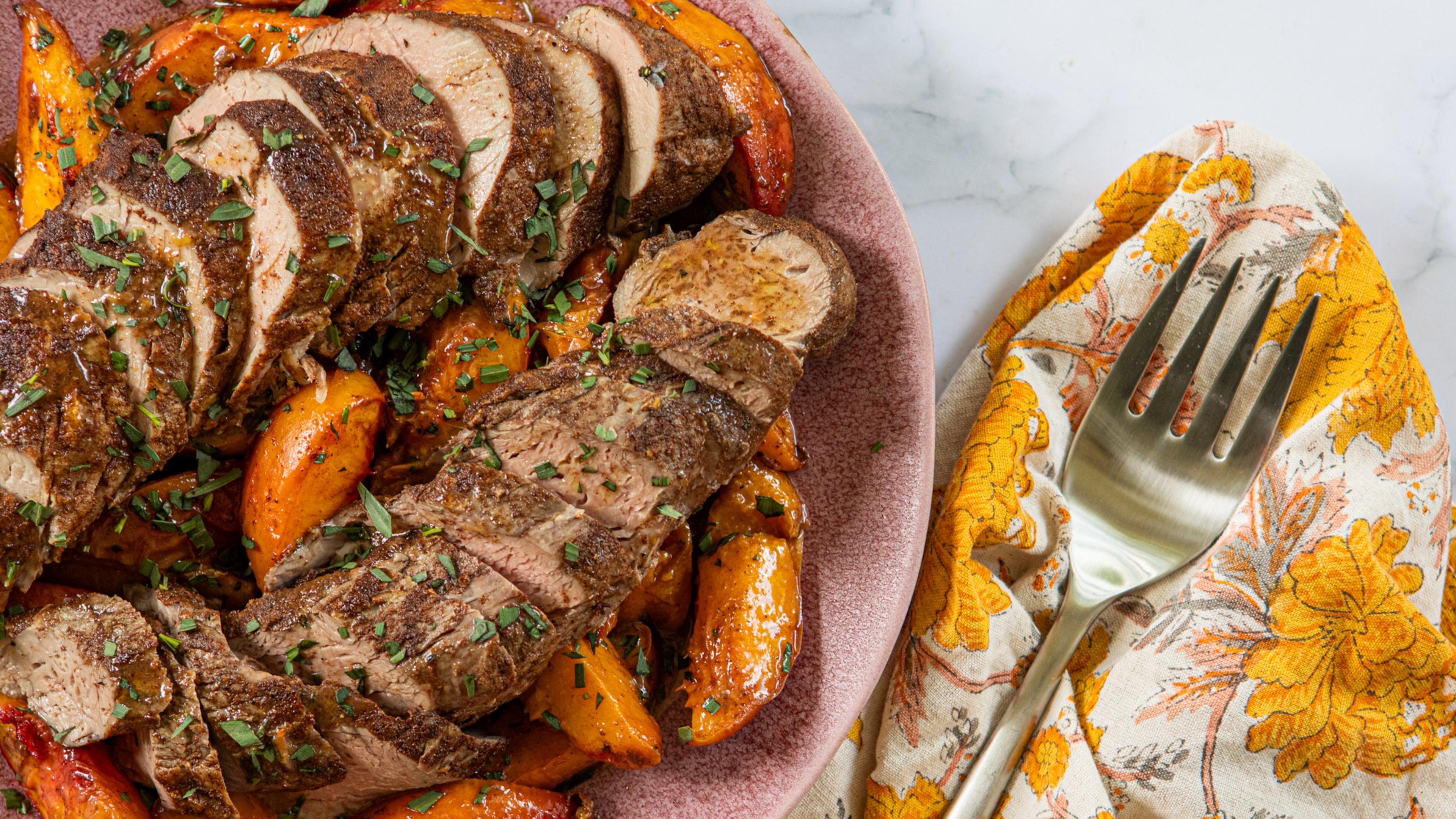 Fresh tarragon complements the spice blend in this roasted pork tenderloin and peaches recipe. (Aaliyah Man for the AJC/Food styling by Kate Williams)