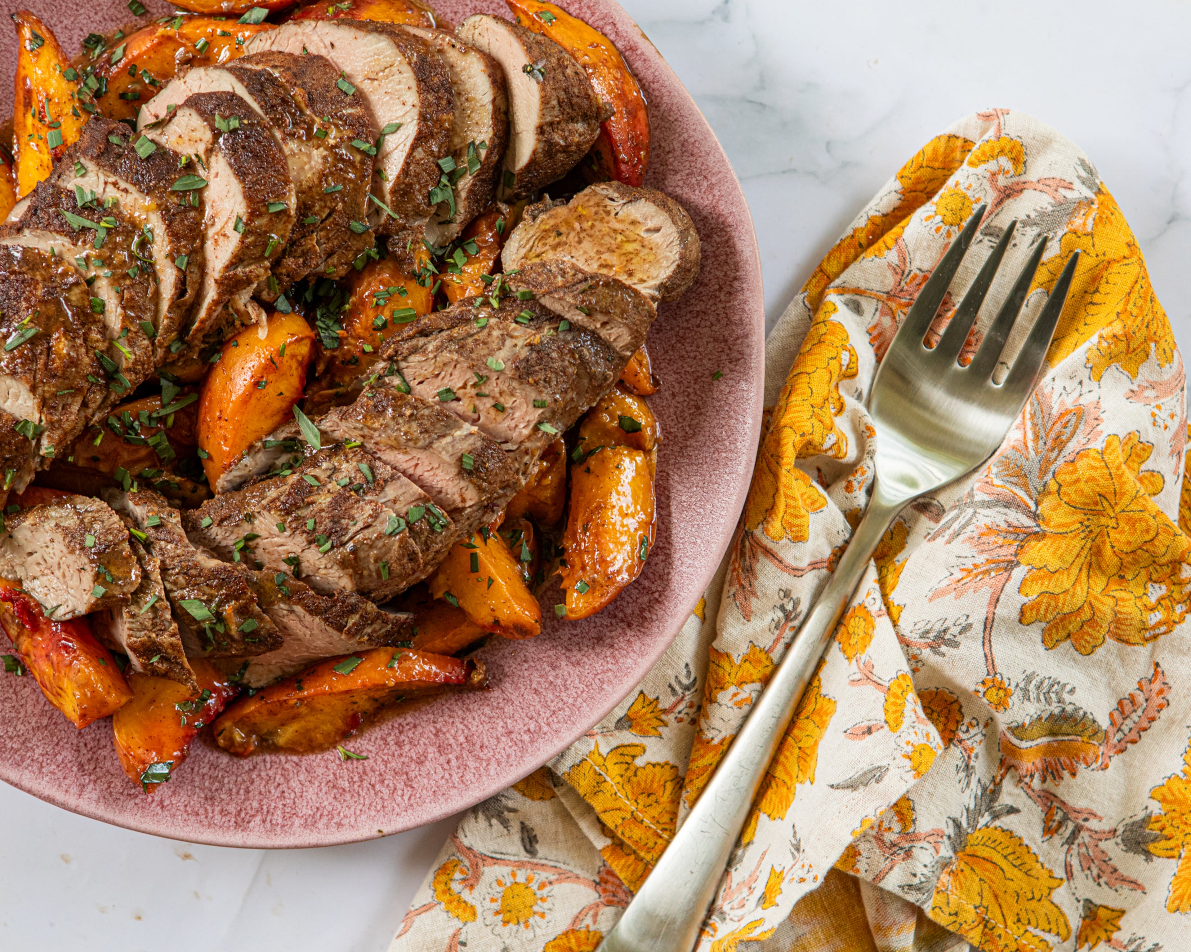 Roasted pork tenderloin and peaches. (Aaliyah Man for the AJC/food styling by Kate Williams)