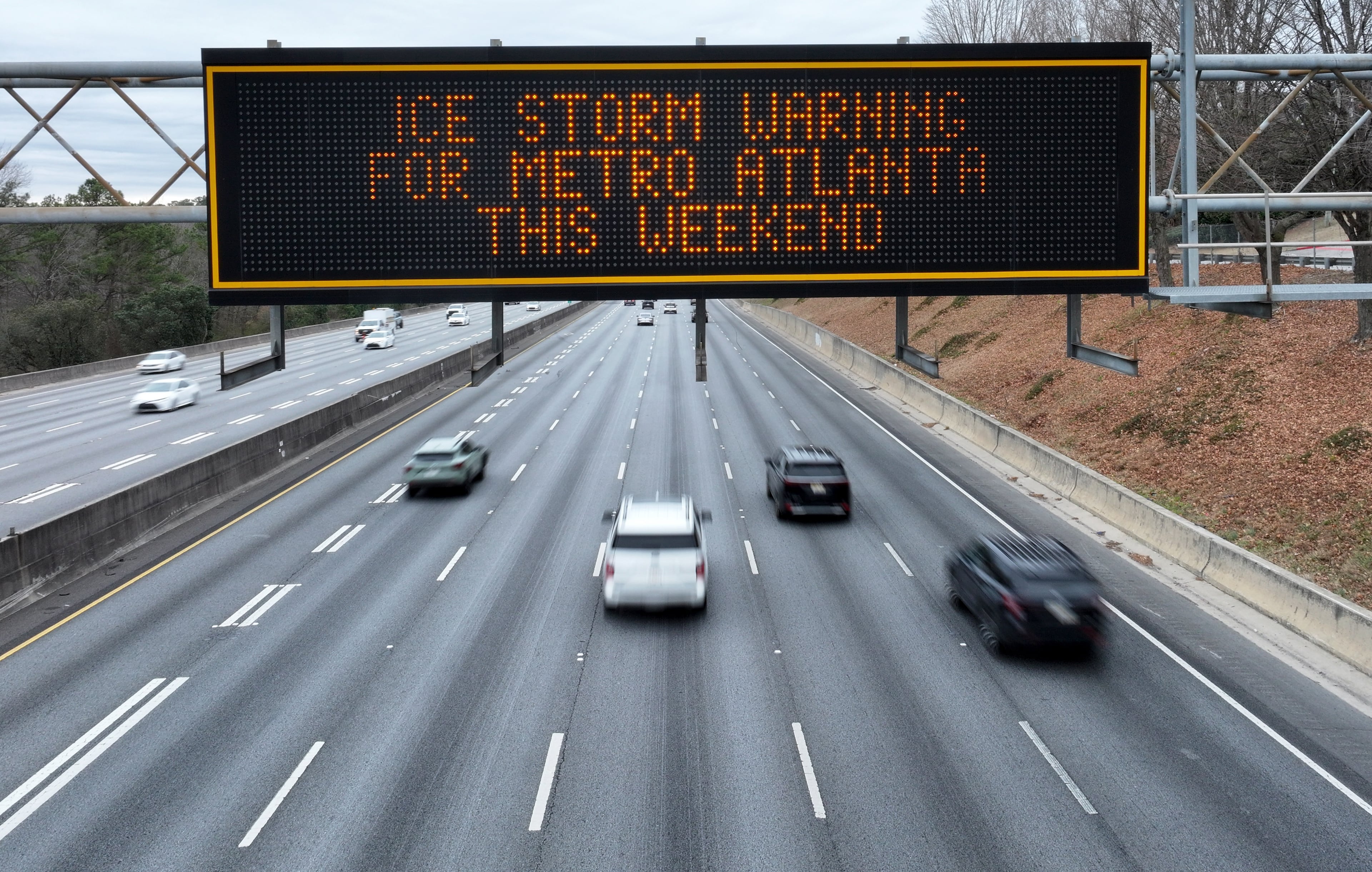 An ice storm warning sign is displayed on I-85 near Clairmont Road exit, Saturday, Jan. 24, 2026, in Atlanta. In metro Atlanta, an ice storm warning went into effect at 1 p.m. Saturday. It’s expected to last until Monday morning, the National Weather Service said. (Hyosub Shin/AJC)