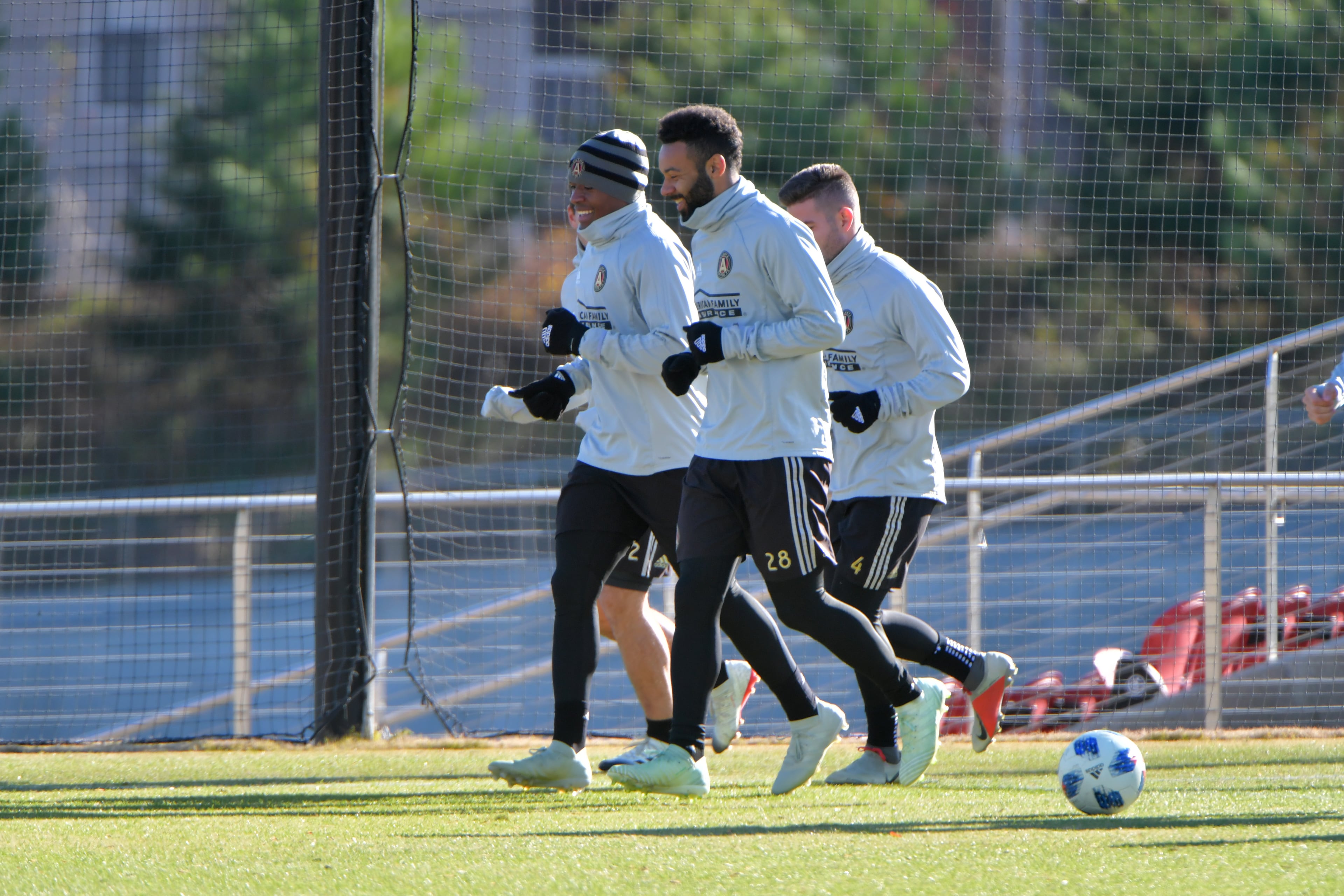 Midfielders Darlington Nagbe (left) and Andrew Wheeler-Omiunu (28) smile as they warm up during Tuesday's practice at Children's Healthcare of Atlanta Training Ground in Marietta. (Hyosub Shin/hshin@ajc.com)