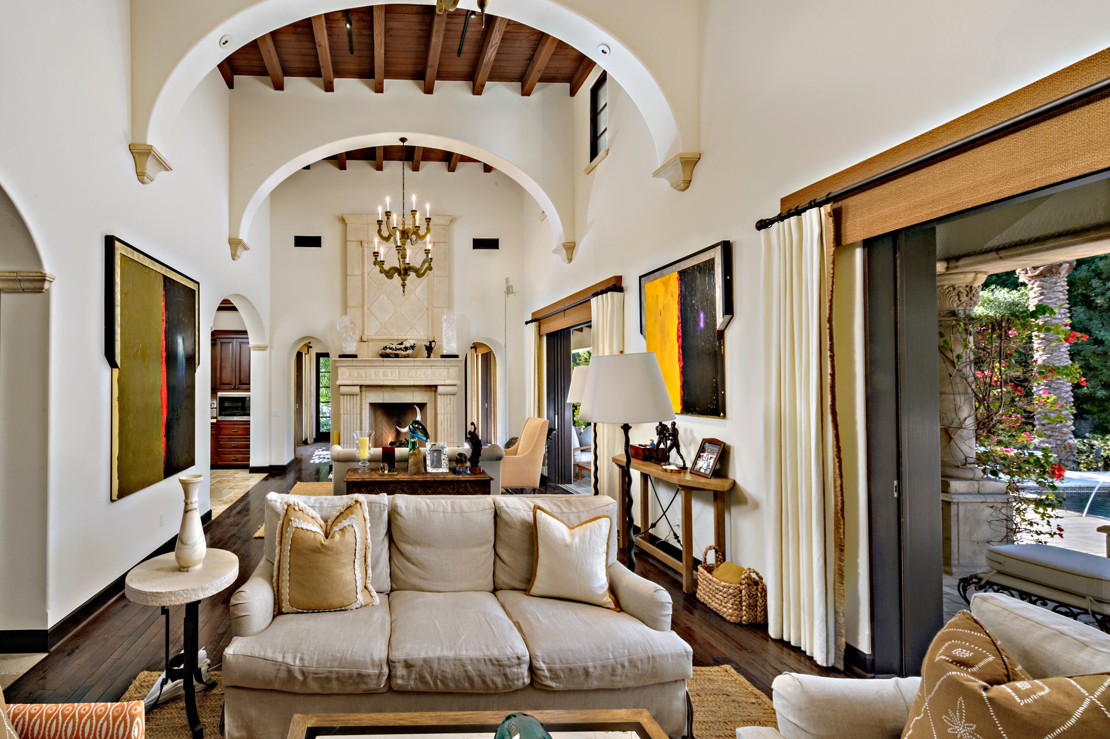 A stone fireplace is the focal point on one wall of the living room. Rocky star and all-around action movie legend Sylvester Stallone has put his desert home in a gated La Quinta, Calif., community up for sale at $4.2 million. The 5,173-square-foot, four-bedroom, 4.5-bathroom home features details such as arched doorways, exposed beams, and plenty of space to hang his paintings, since he’s not just an actor—he’s an artist, too. Listing courtesy of Josh Reef, Hurwitz James Company