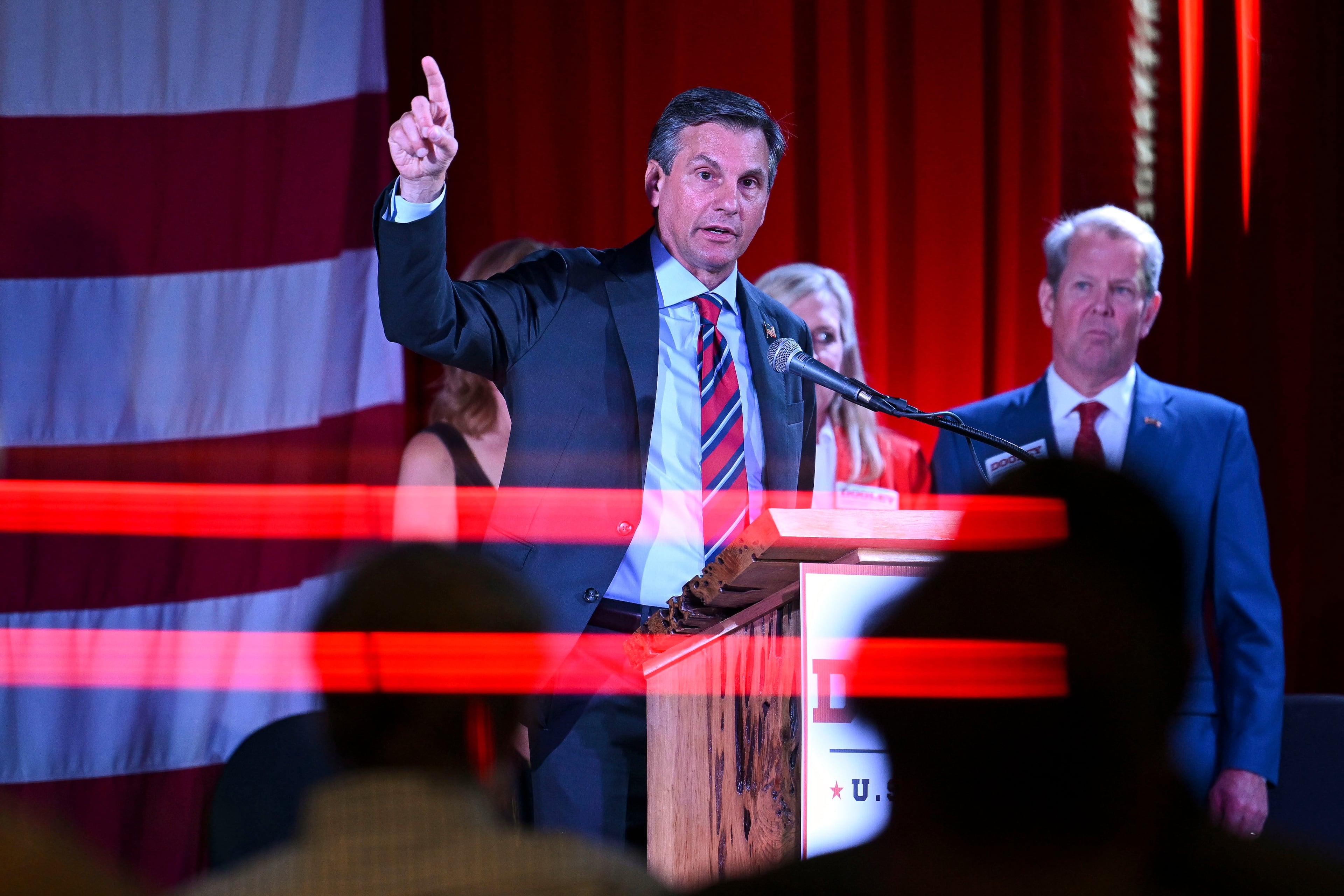 Republican candidate for U.S. Senate Derek Dooley (center) speaks to supporters at his election night party Tuesday, May 19, 2026, as Georgia Gov. Brian Kemp watches. (Daniel Varnado/AJC)