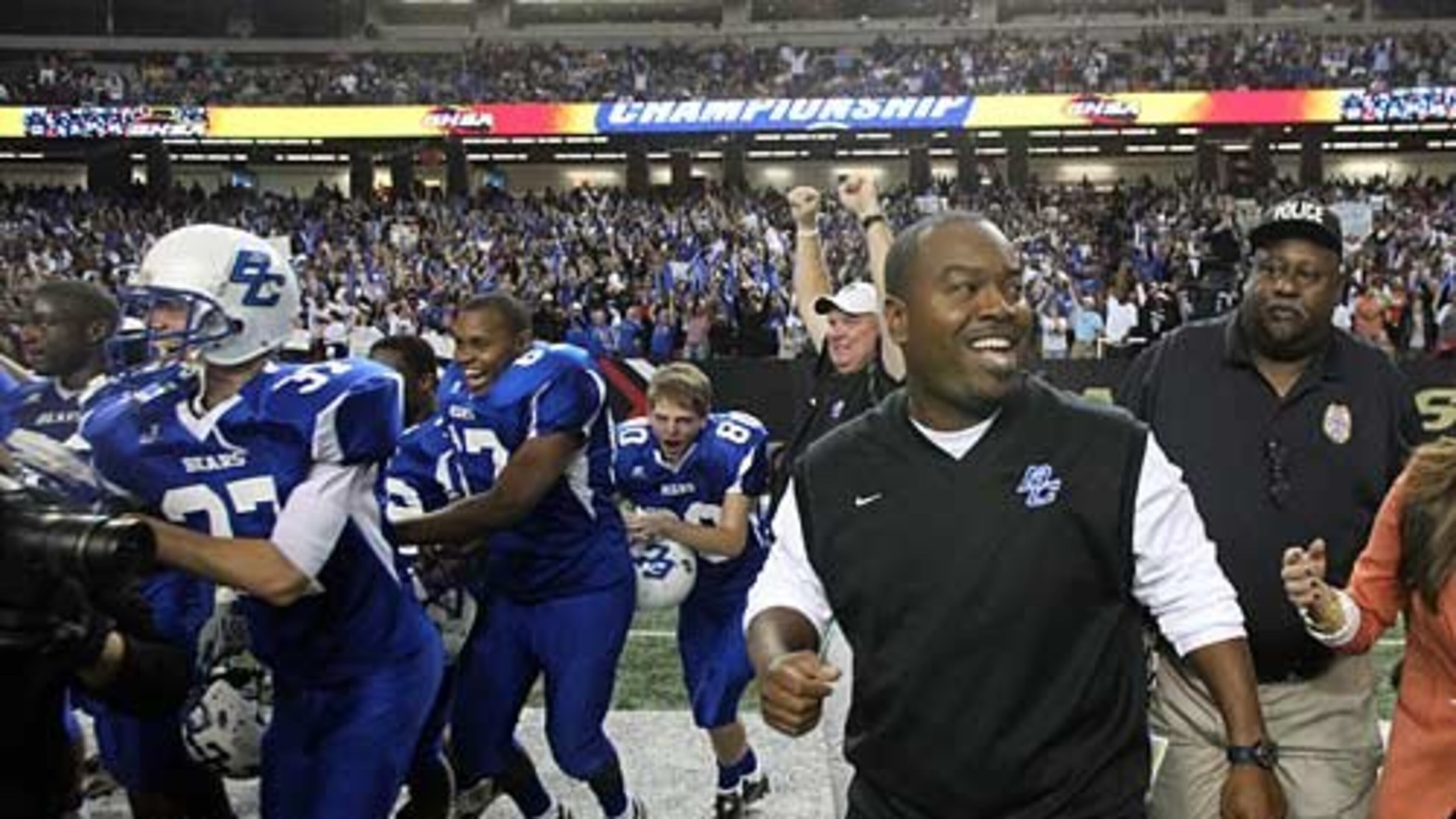 Burke County coach Eric Parker smiles as he and the rest of the Burke County football team celebrates their 28-14 win over Peach County in the Class AAA Georgia state high school football championship. Peach County lead Burke County 14-6 at the end of the first half.