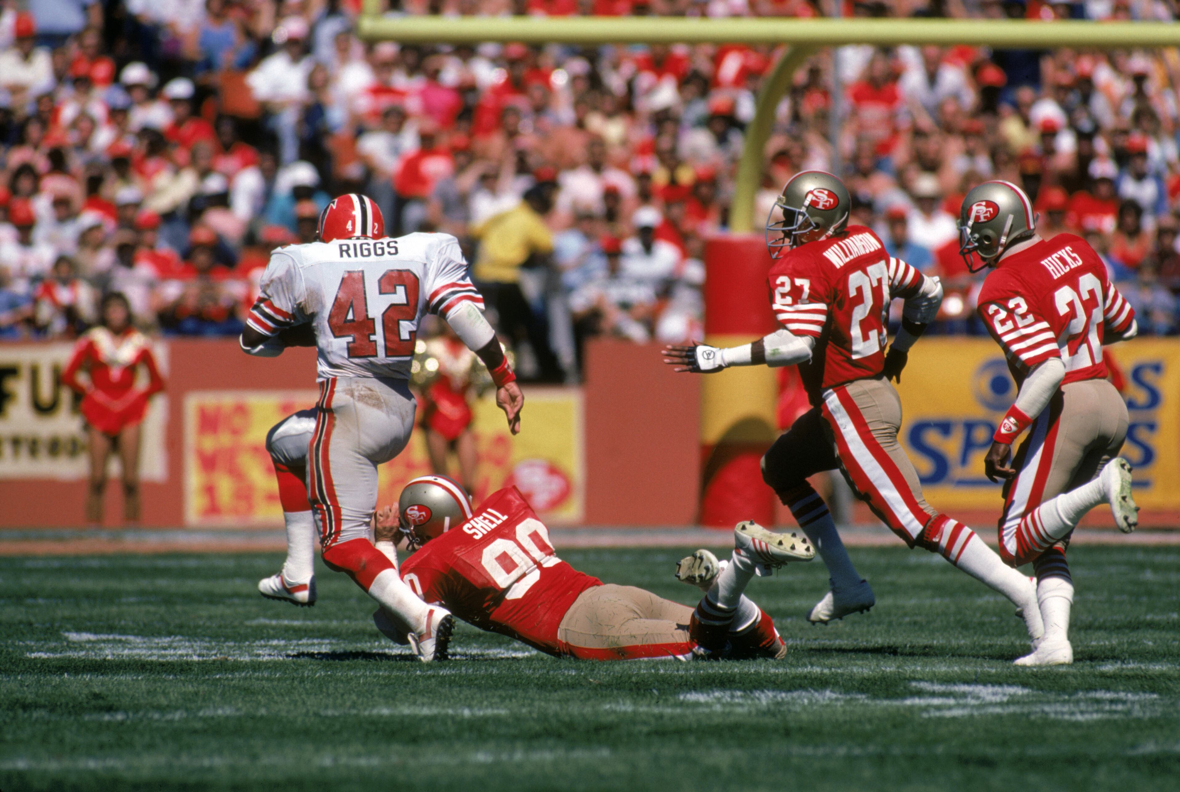 Running back Gerald Riggs of the Falcons rushes past linebacker Todd Shell, defensive back Carlton Williamson and Dwight Hicks of the 49ers during the 1985 season. (Photo by George Rose/Getty Images)
