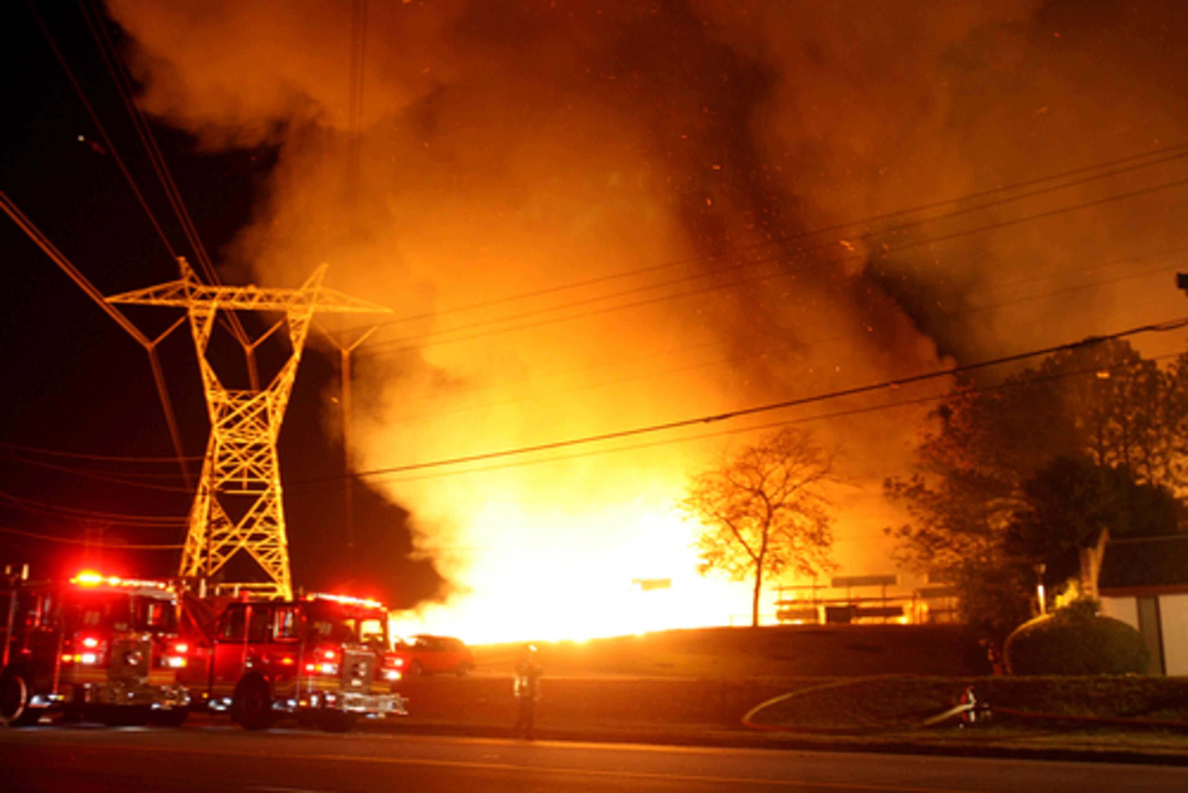 The flames threatened power lines as the wind blew sparks and ashes.