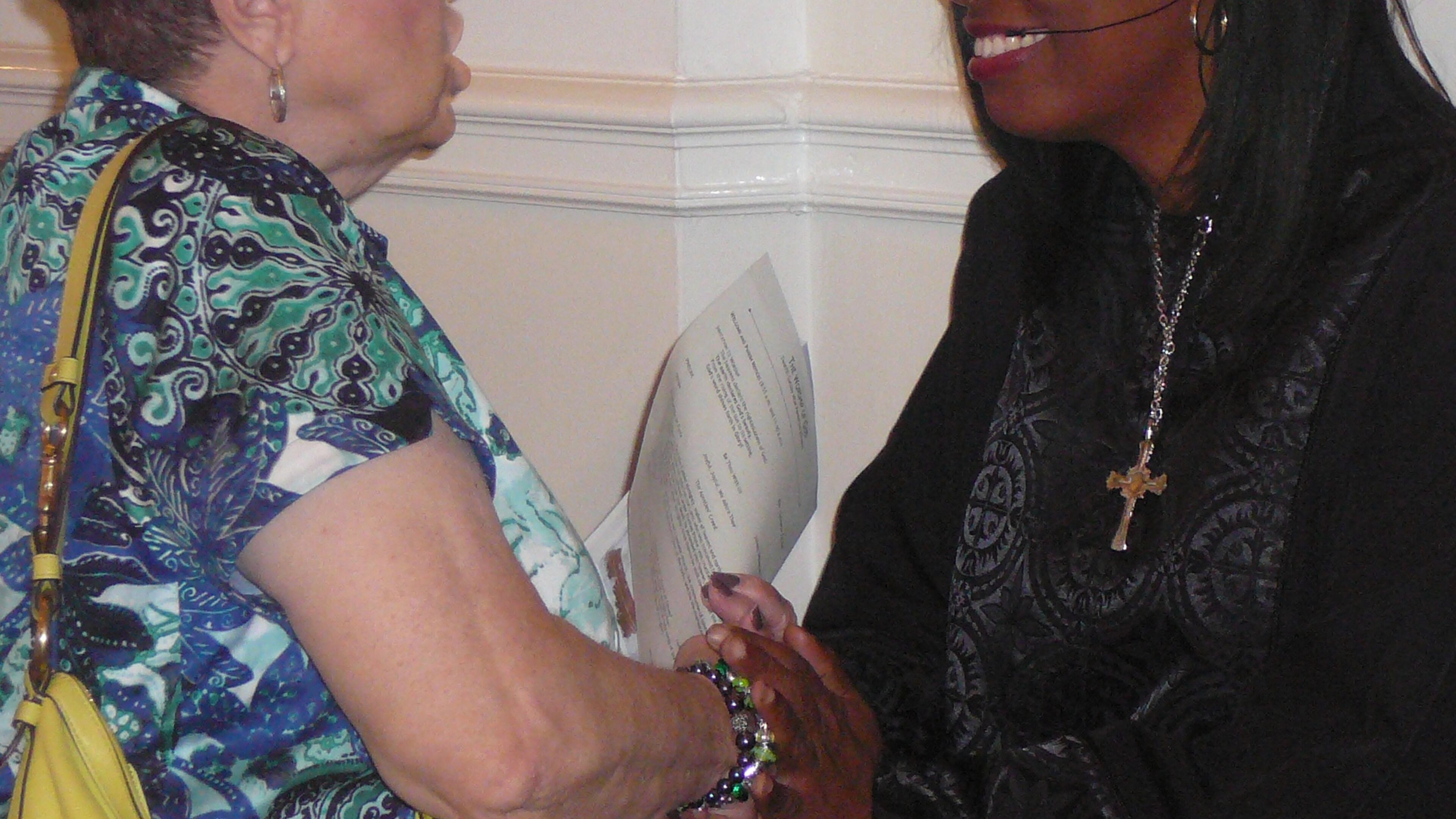 Rev. Claudette Farmer greets church member Rosemary Strickland after a service at the First United Methodist Church of Marietta. Farmer, who is the only minority on the staff, left the corporate world to go into the ministry.