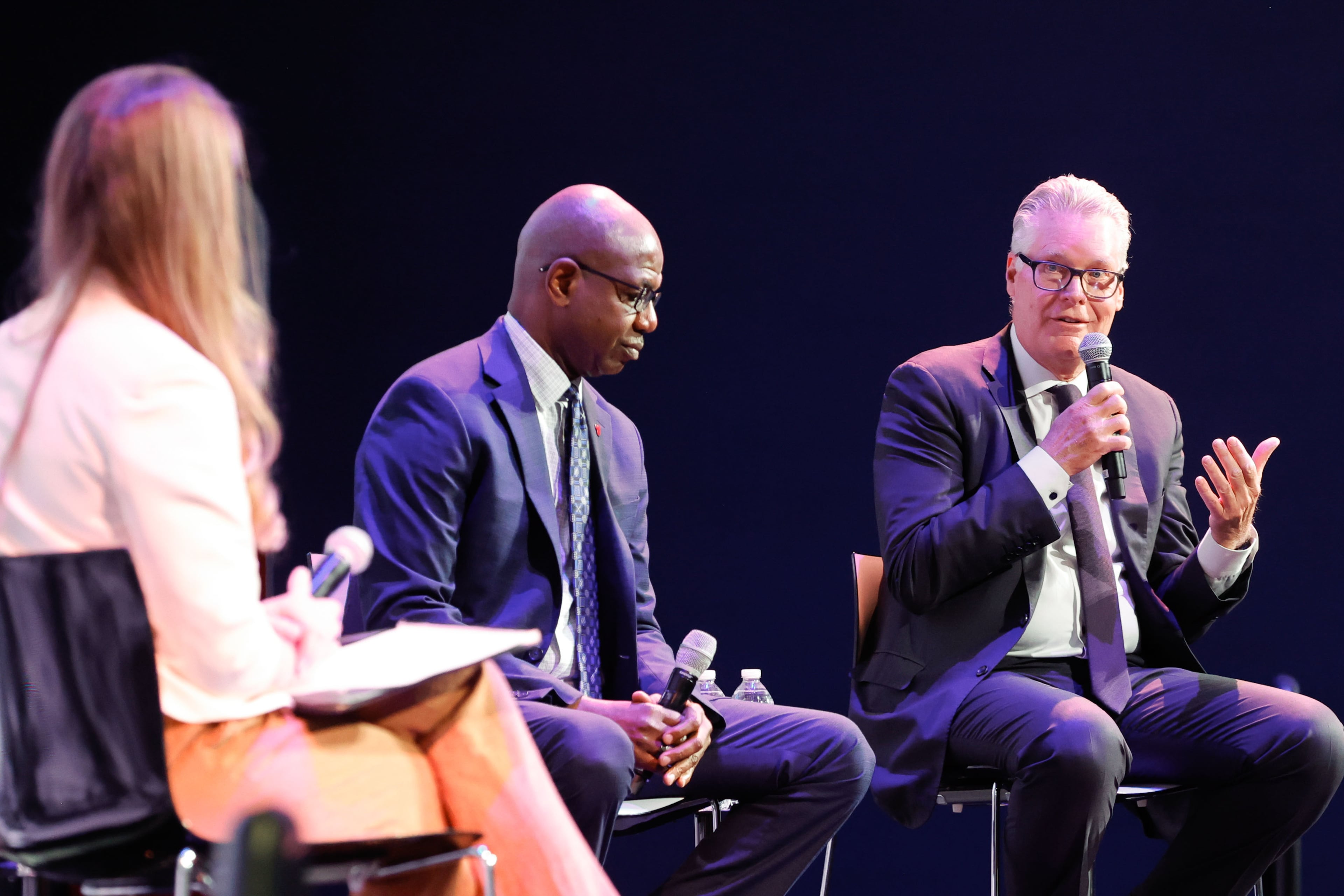 Delta Air Lines CEO Ed Bastian (from right) and Ricky Smith, general manager of Hartsfield-Jackson Atlanta International Airport, join AJC reporter Emma Hurt for a panel discussion at the Delta Flight Museum on Sept. 9. (Natrice Miller/AJC)