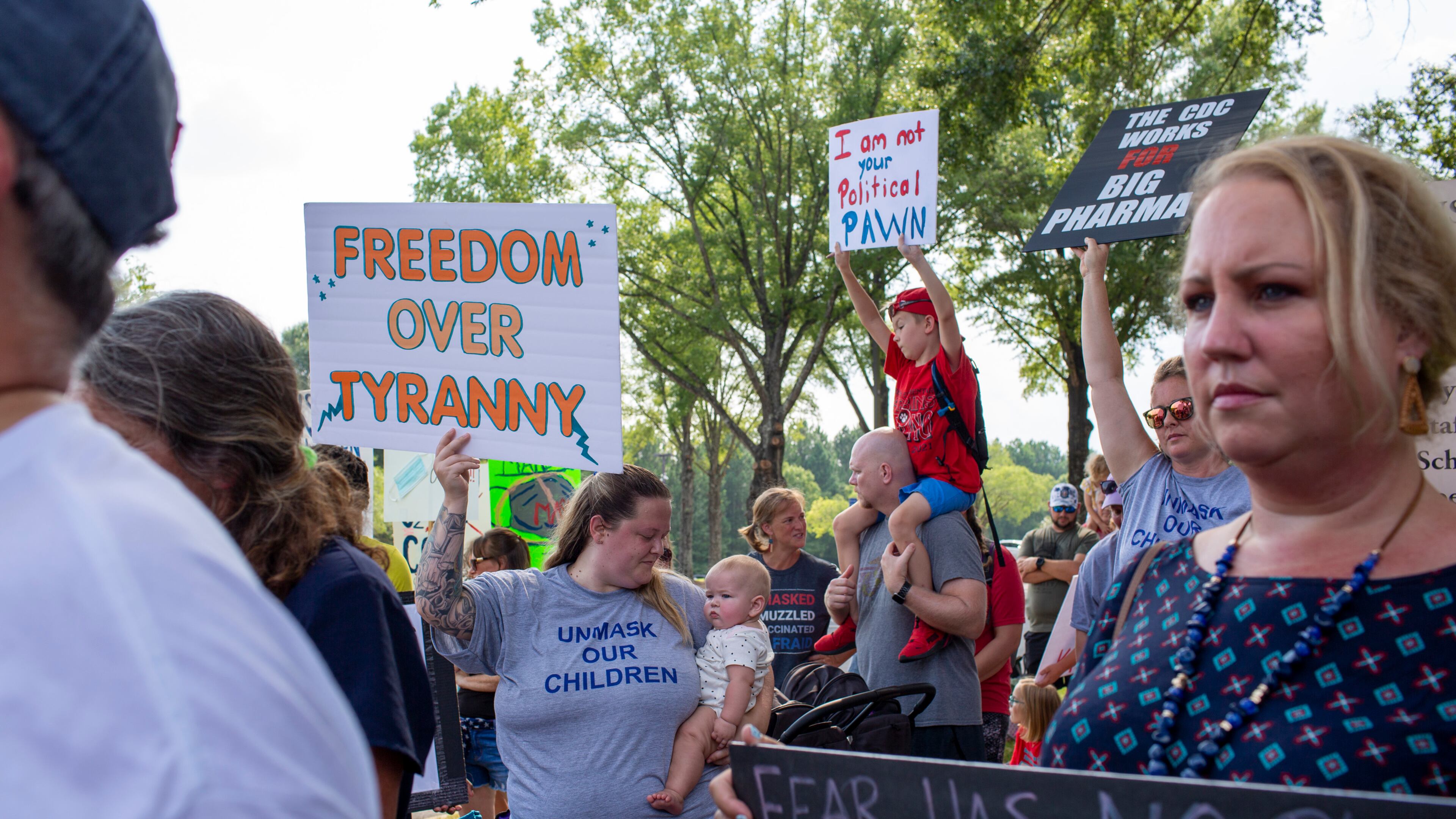 People protest in July against the Gwinnett County school system's policy mandating masks be worn in district facilities and on buses. Masks are just one of many issues that have placed education at the center of this year's campaigns and in the General Assembly session. (Rebecca Wright for the Atlanta Journal-Constitution)