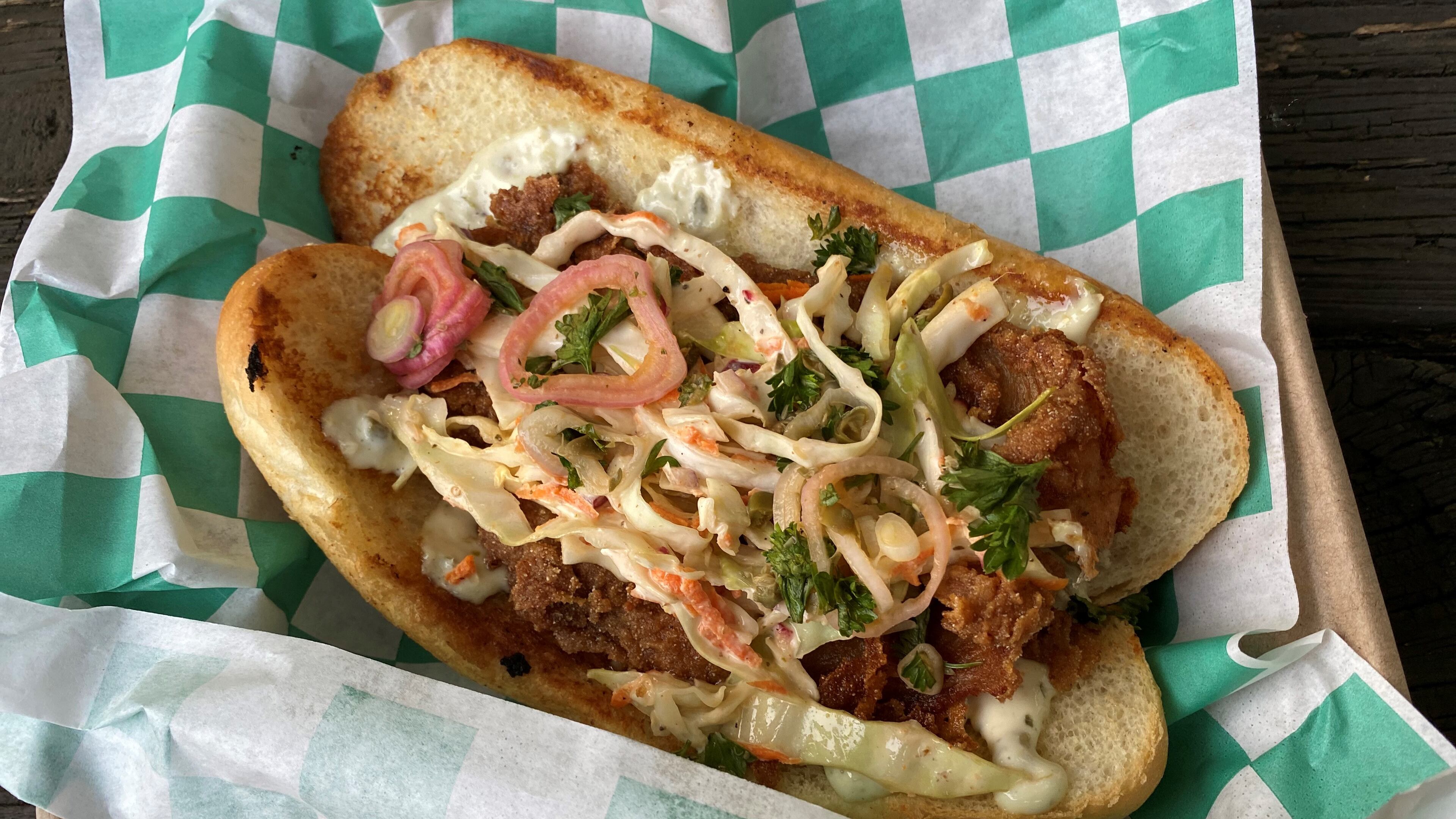 LLoyd’s offers a fresh take on the classic fish sandwich — with both slaw and a parsley and shallot salad inspired by St. John restaurant in London. Wendell Brock for The Atlanta Journal-Constitution