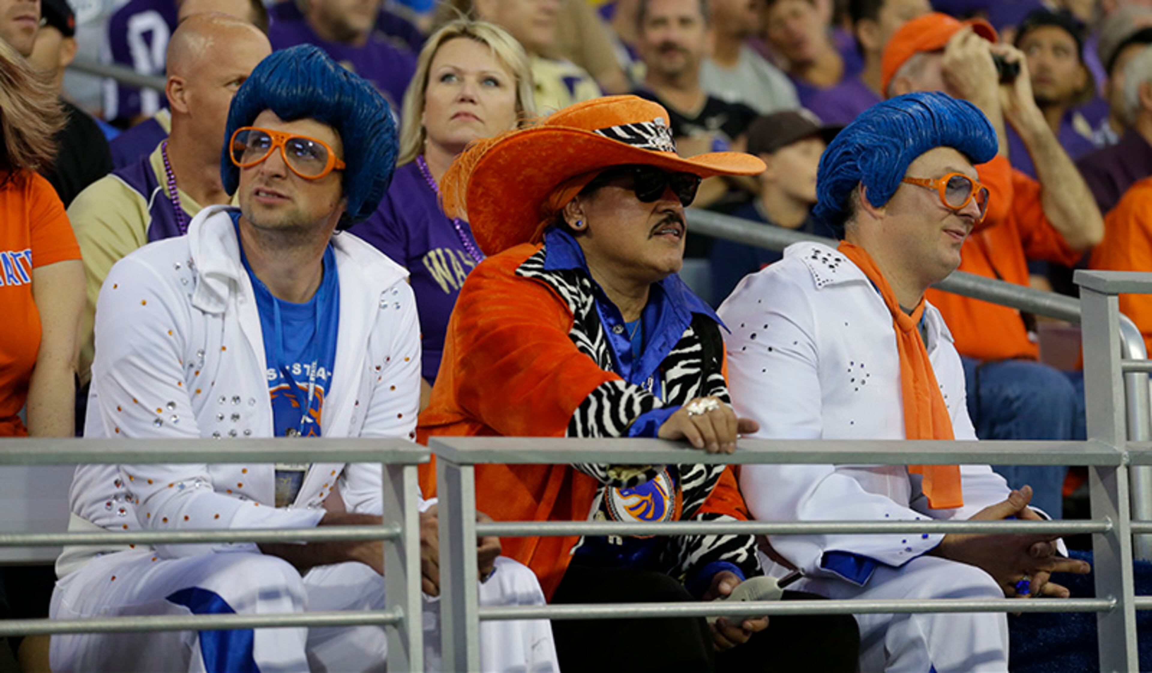 Boise State fans dressed in Elvis and other costumes watch action in the first half of a NCAA college football game against Washington, Saturday, Aug. 31, 2013, in Seattle.