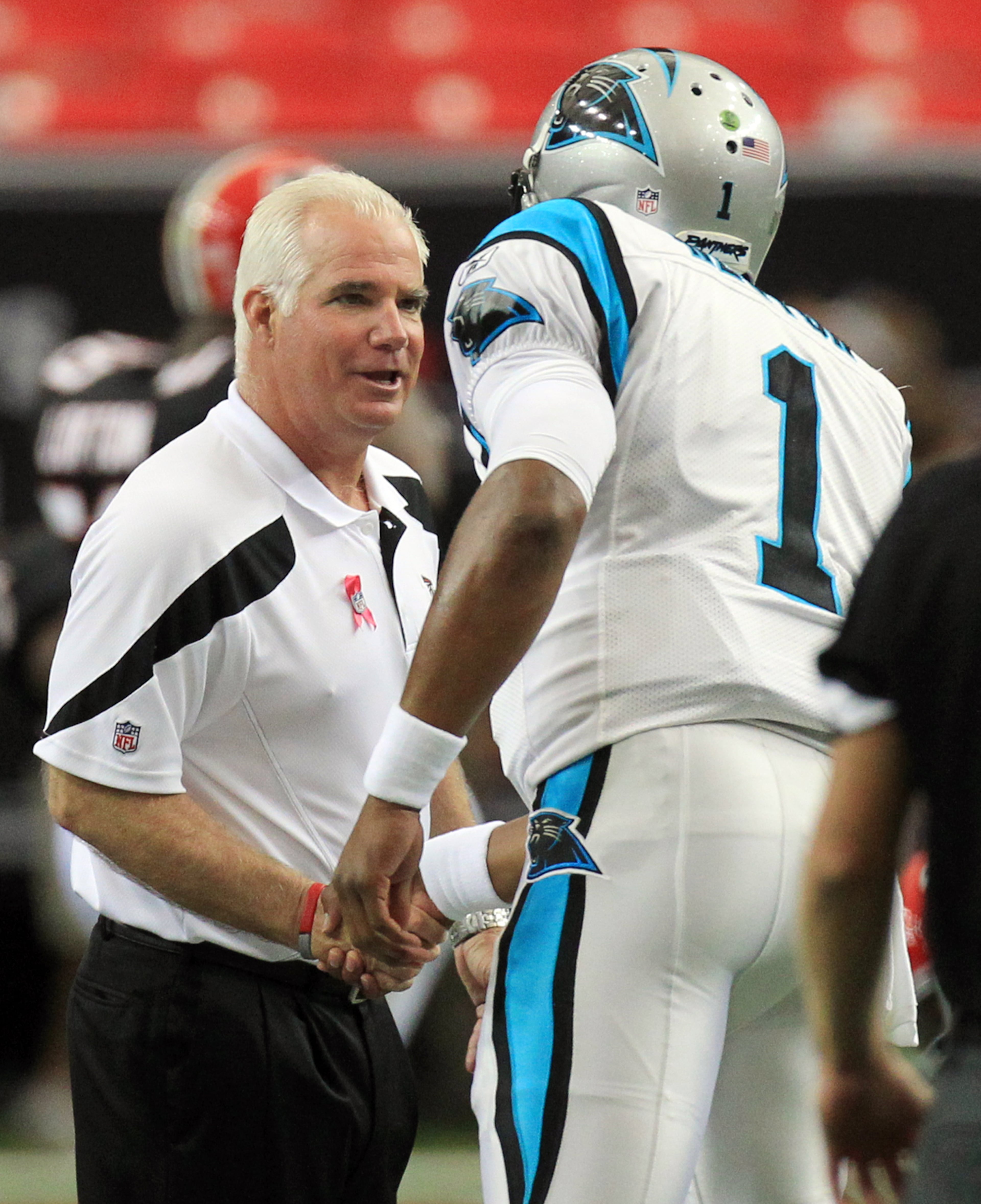 Falcons head coach Mike Smith and Panthers quarterback Cam Newton greet each other at mid-field during pregame warmups at the Georgia Dome in Atlanta on Sunday, Oct. 16, 2011. Curtis Compton ccompton@ajc.com