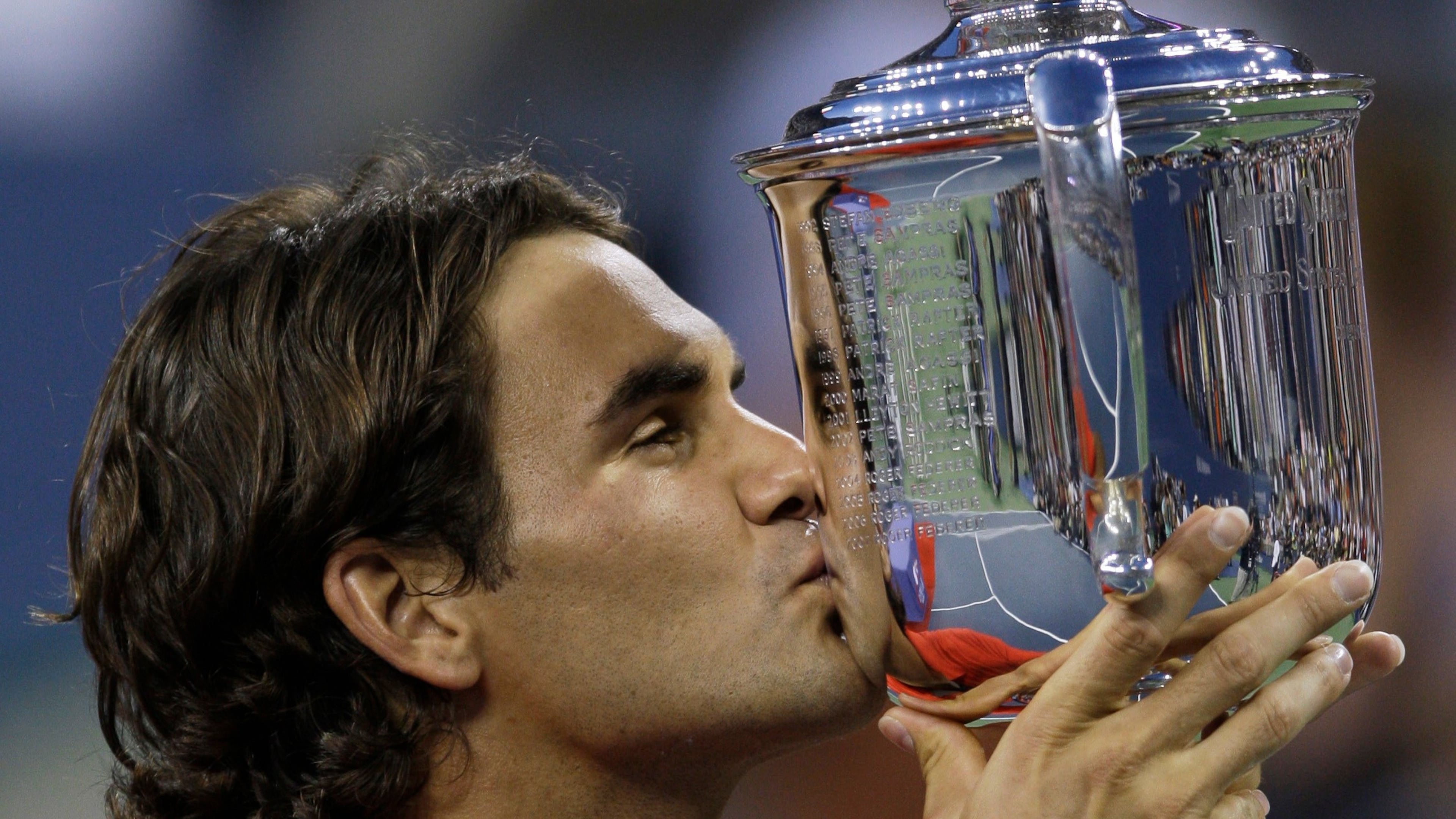FILE - Roger Federer, of Switzerland, kisses the championship trophy after winning the men's finals championship over Andy Murray, of Britain, at the U.S. Open tennis tournament in New York, Monday, Sept. 8, 2008. (AP Photo/Charles Krupa, File)