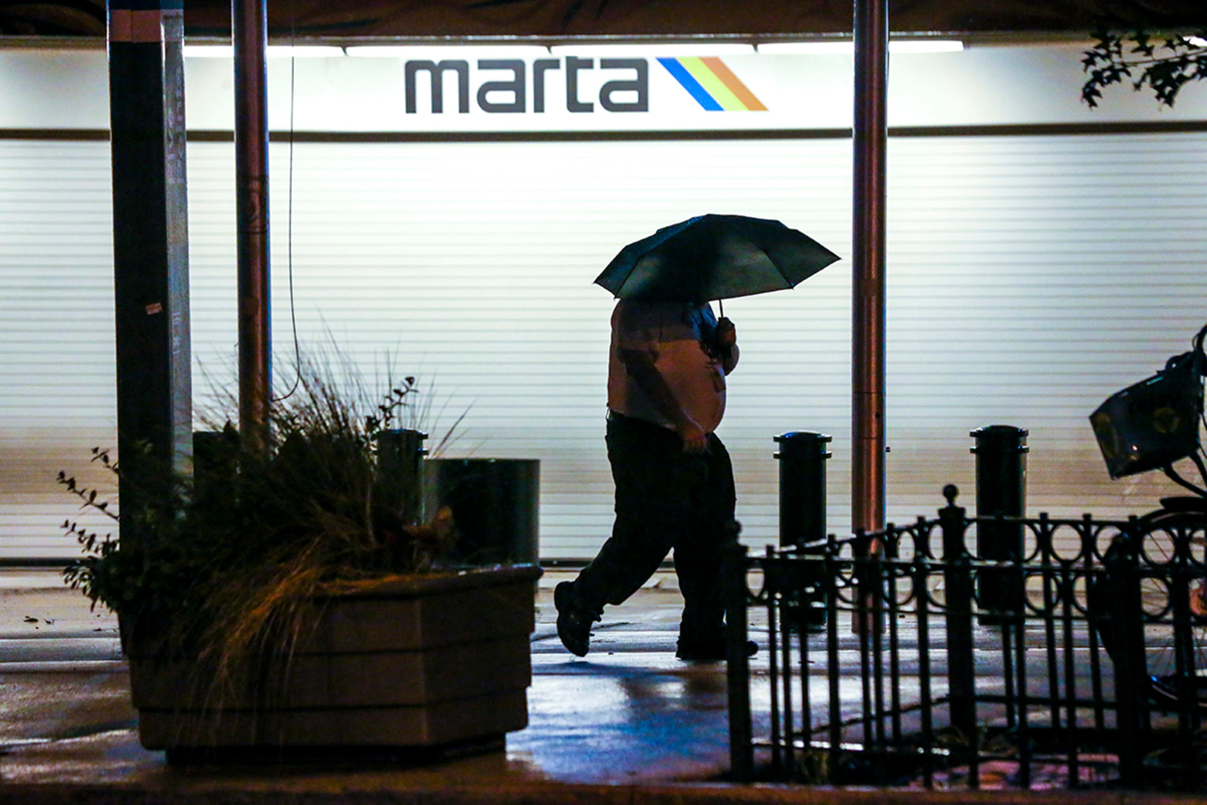 September 11, 2017 Atlanta: A man strolls past the closed Five Points MARTA Station on Monday, Sept. 11, 2017 after MARTA shut down all its public transportation while tropical storm, Irma moved to Atlanta on Monday, Sept. 11, 2017. The storm claimed at least one life in Georgia, state emergency management officials said Monday. The death occurred in Worth County. Further details werenât immediately available. Irmaâs staggering march up into northern Florida was expected to bring high winds and heavy rains to Atlanta Monday afternoon â though perhaps not quite as high or as heavy as earlier feared. Georgia Powerâs outage map showed 400,000 of its customers were down, and the electric membership cooperatives, as of 12:45 p.m., added another 268,000 to the total. Most of the failures were along the Georgia coast and in South Georgia. But the outages began to creep northward: 22,000 metro Atlanta customers had no power as of 12:20 p.m., the Georgia Power map showed. JOHN SPINK/JSPINK@AJC.COM