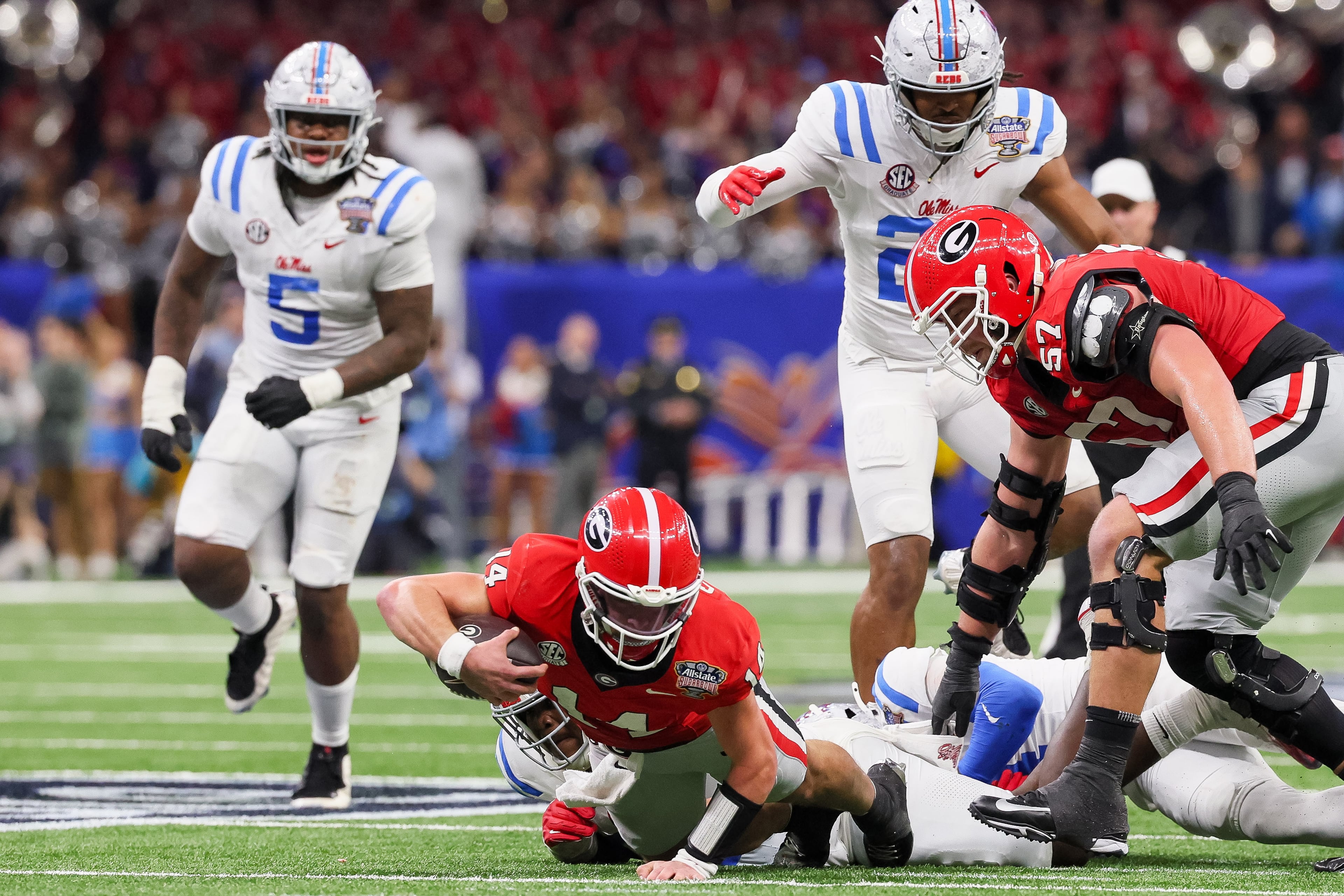 Georgia Bulldogs quarterback Gunner Stockton (14) dives for extra yards but is stopped by the Ole Miss Rebels defense short of a first down during the third quarter of the College Football Playoff quarterfinal game at the Sugar Bowl in the Caesars Superdome, Thursday, Jan. 1, 2026, in New Orleans. (Jason Getz/AJC)