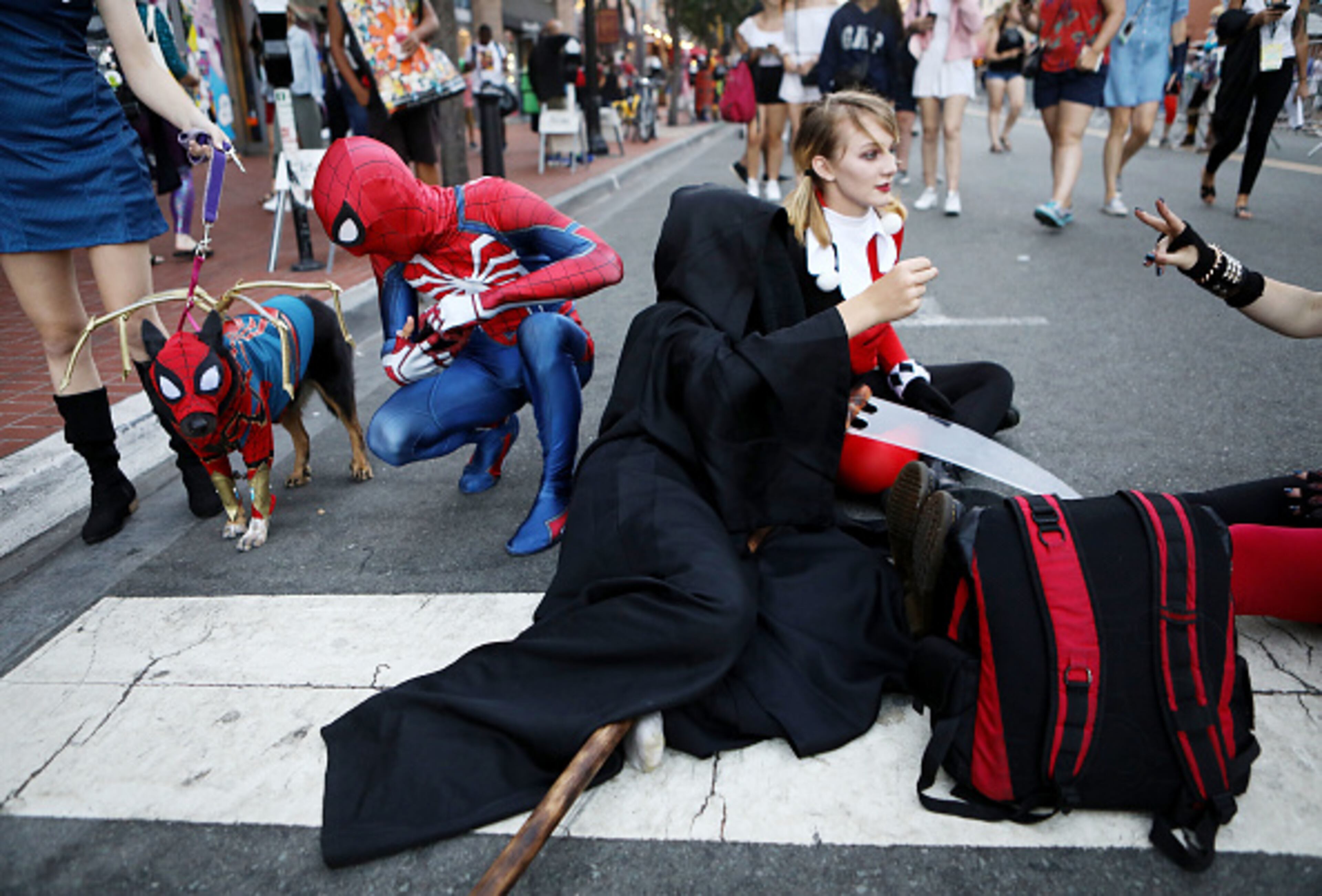 SAN DIEGO, CA - JULY 19: Cosplayers along with a dog dressed as Spider-Man gather outside San Diego Comic-Con on July 19, 2018 in San Diego, California. Thousands of revelers are arriving for the festivities at the annual comic and entertainment convention. (Photo by Mario Tama/Getty Images)