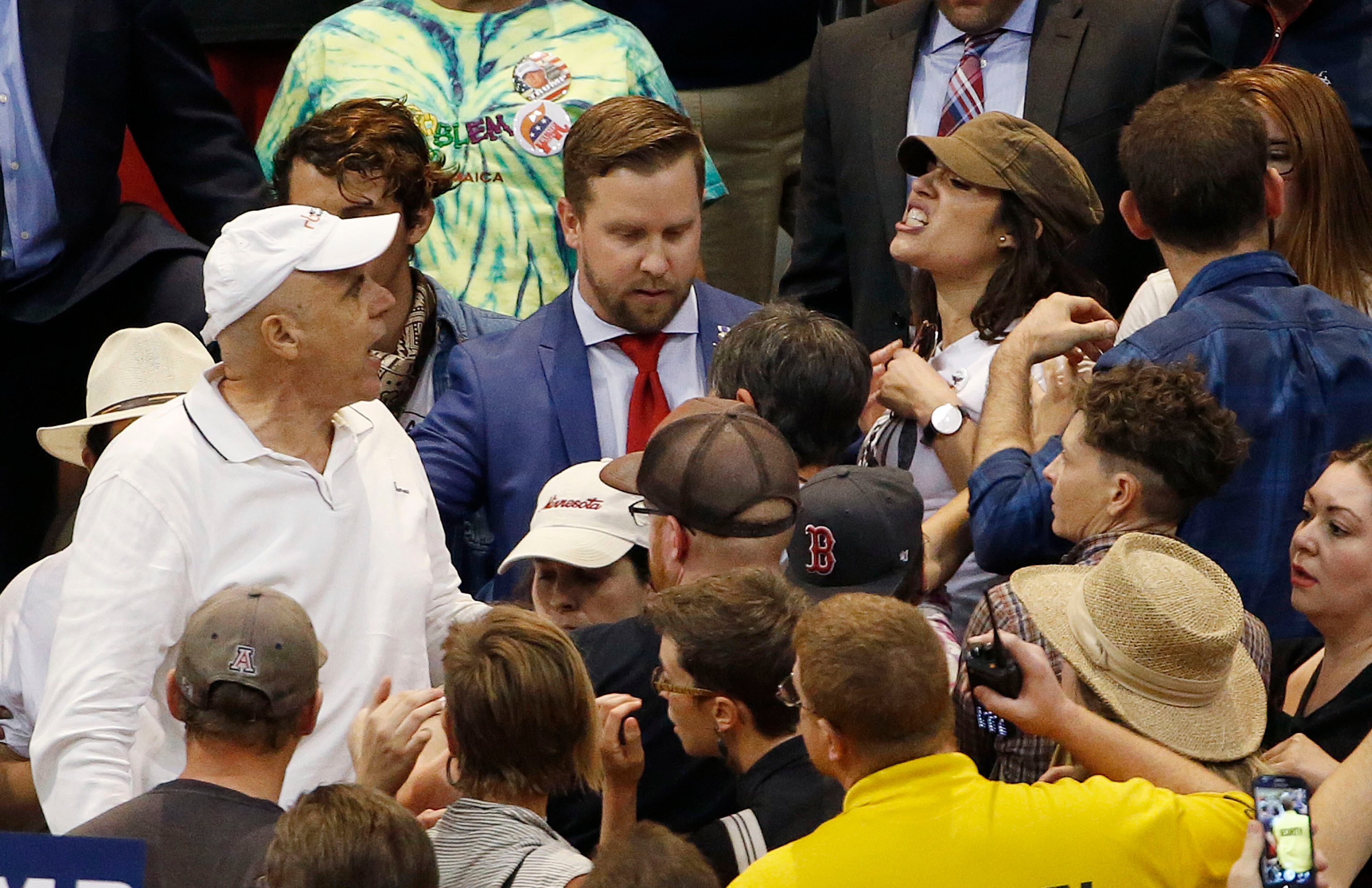 A supporter of Republican presidential candidate Donald Trump, left, shouts with an anti-Trump protester, second from right at top, as the candidate speaks during a campaign rally Saturday, March 19, 2016, in Tucson, Ariz. (AP Photo/Ross D. Franklin)