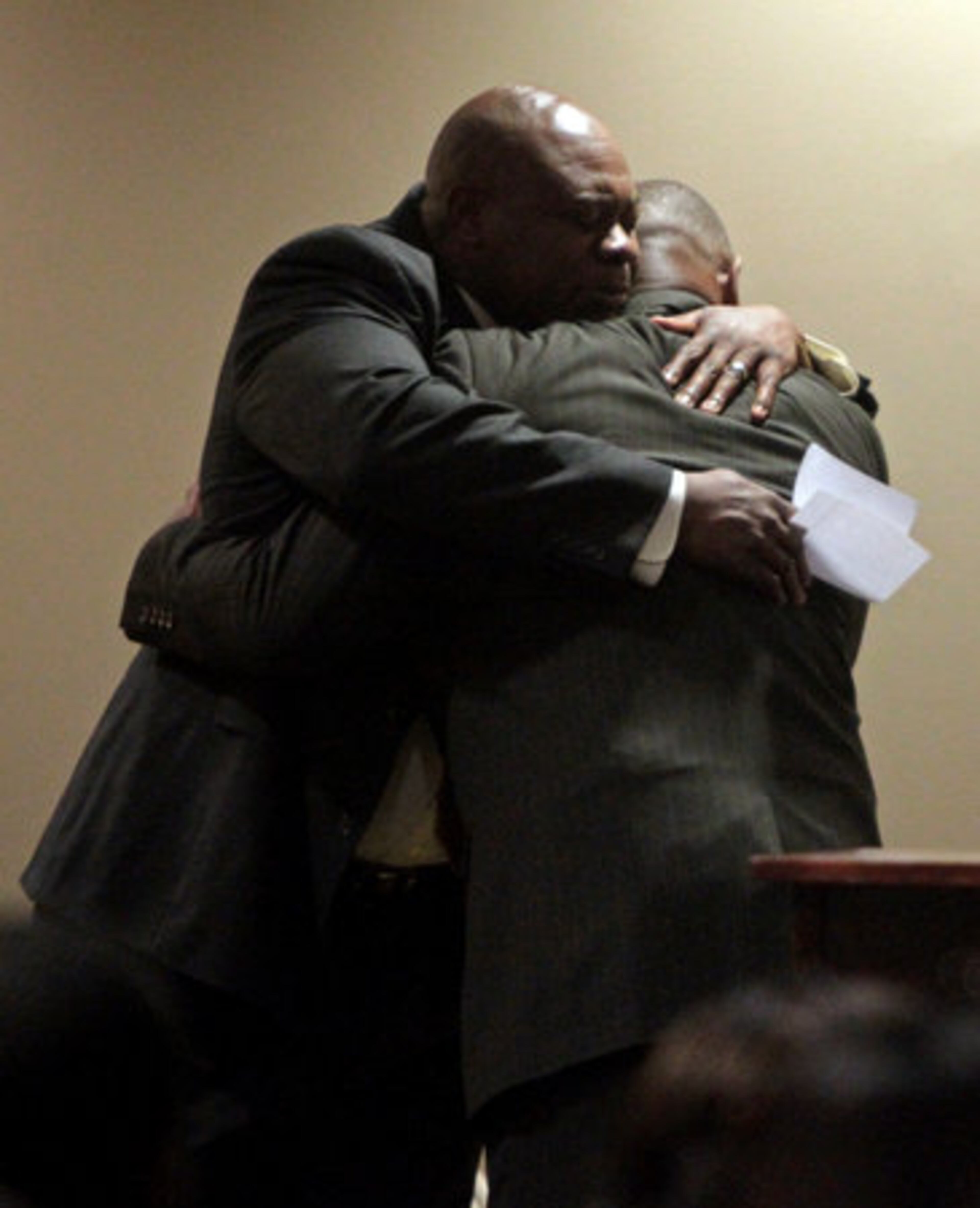 Former Georgia Tech running back Eddie Lee Ivery, right, gets a hug from Georgia Tech chaplain Derrick Moore, facing, after Ivery gave a speech about his friend Drew Hill at Bobby Dodd Stadium Friday afternoon in Atlanta, Ga., March 25, 2011. Hill, a former standout at Georgia Tech and in the NFL, died last Friday after suffering two strokes.