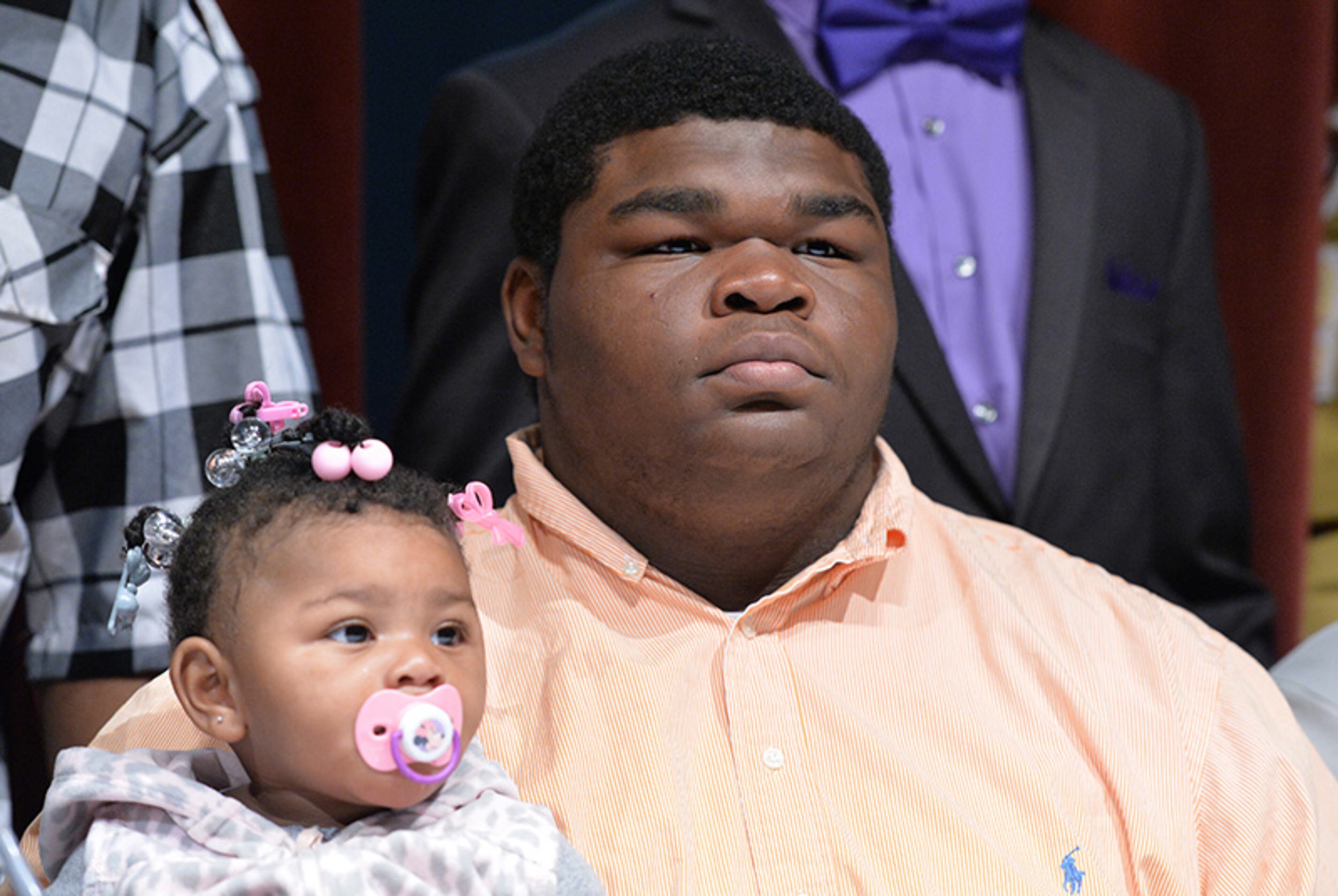 Deandre Bailey poses for photographers after he signed with Arizona Western during signing day at Tucker High School.