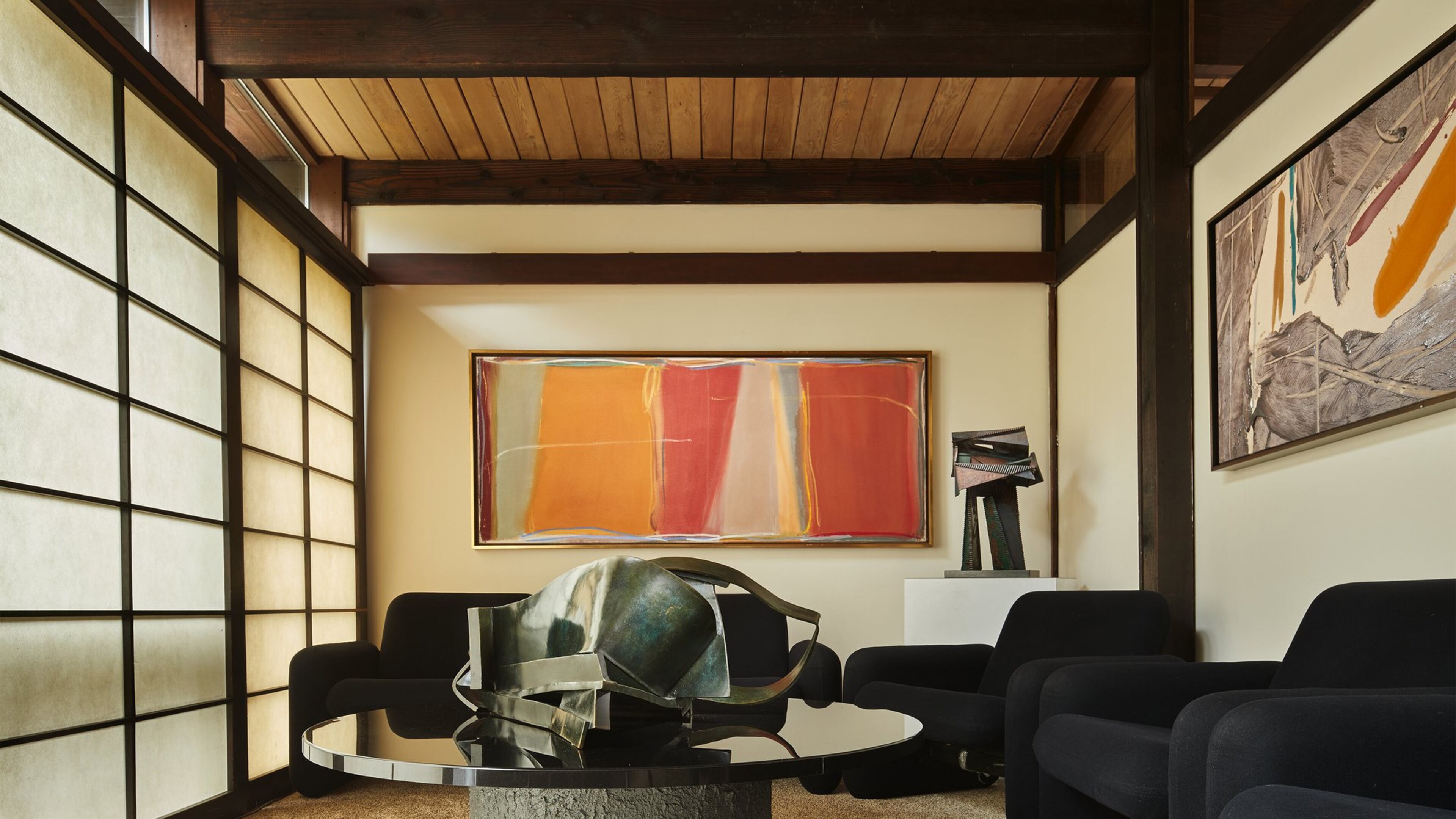 Shoji-style screens delineate the den; they originally served as the sole separation between the living room, bedrooms and kitchen, Anne Fleming says. The paintings are from the ’70s and the ’90s, says Carol Schulte; “They could have been done at the same time, or they could have been yesterday.” “Cut Bank” by Larry Zox (1996) hangs on the far wall, with an untitled acrylic on canvas by Kikuo Saito to the right. “The colors of the art are phenomenal in this room,” Anne says. (Benjamin Benschneider/The Seattle Times/TNS)