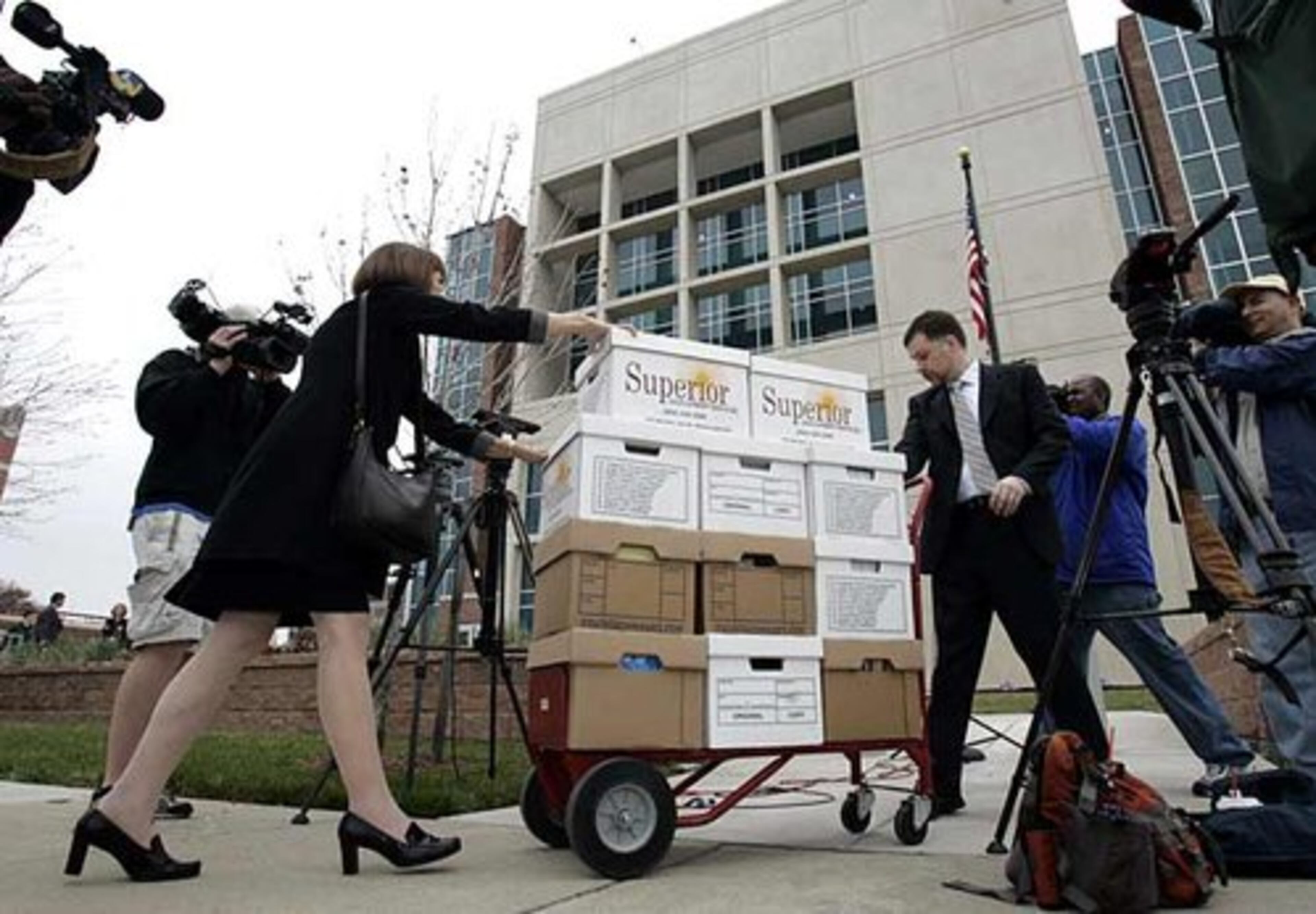 Attorneys wheel a load of boxes up to the U.S. Federal Courthouse for Vick's bankruptcy hearing.