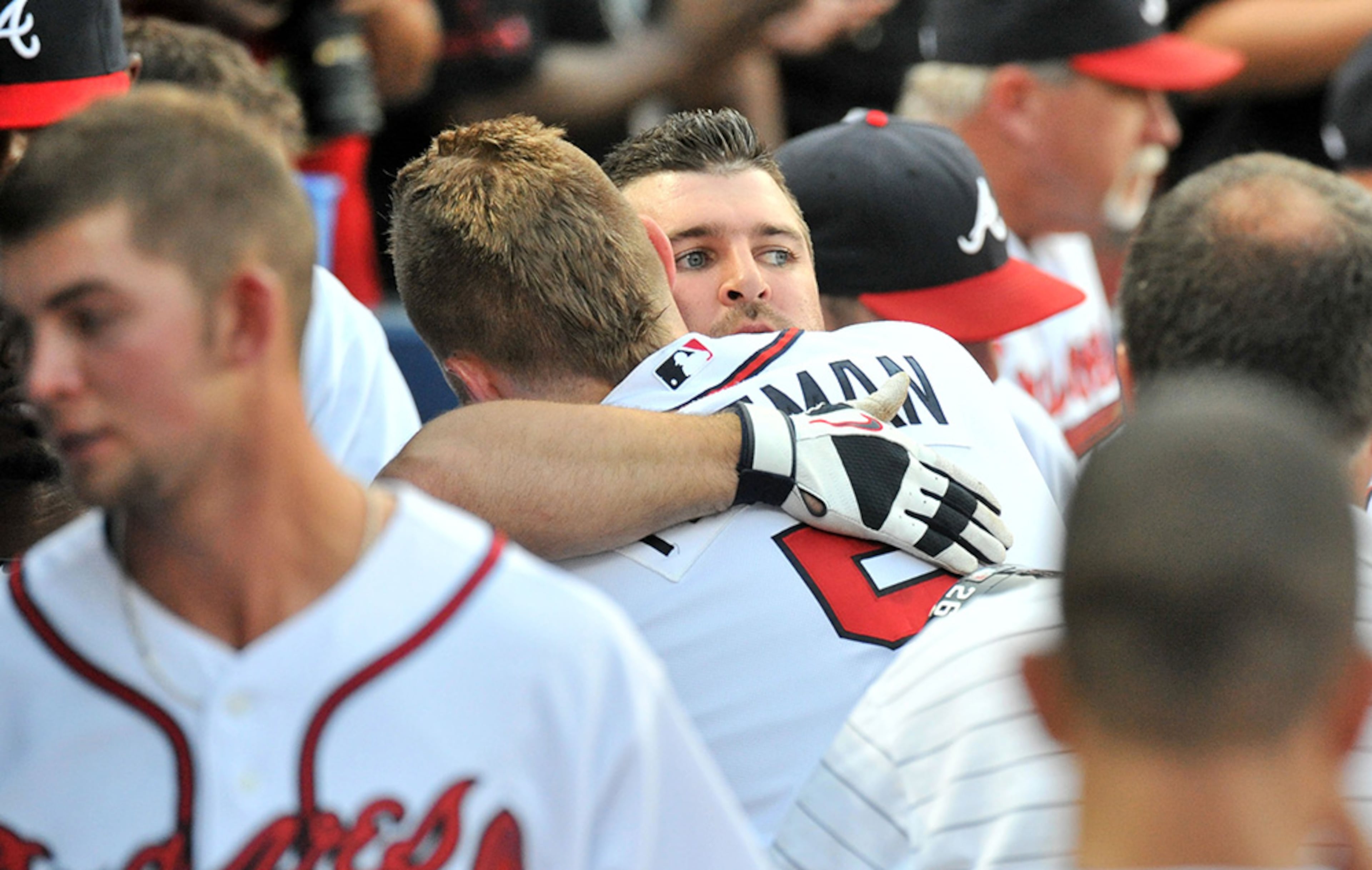 Researchers say the average person spends about one hour a month hugging - that comes out to about 360 hugs a month. In the Braves' dugout there are more than that.
