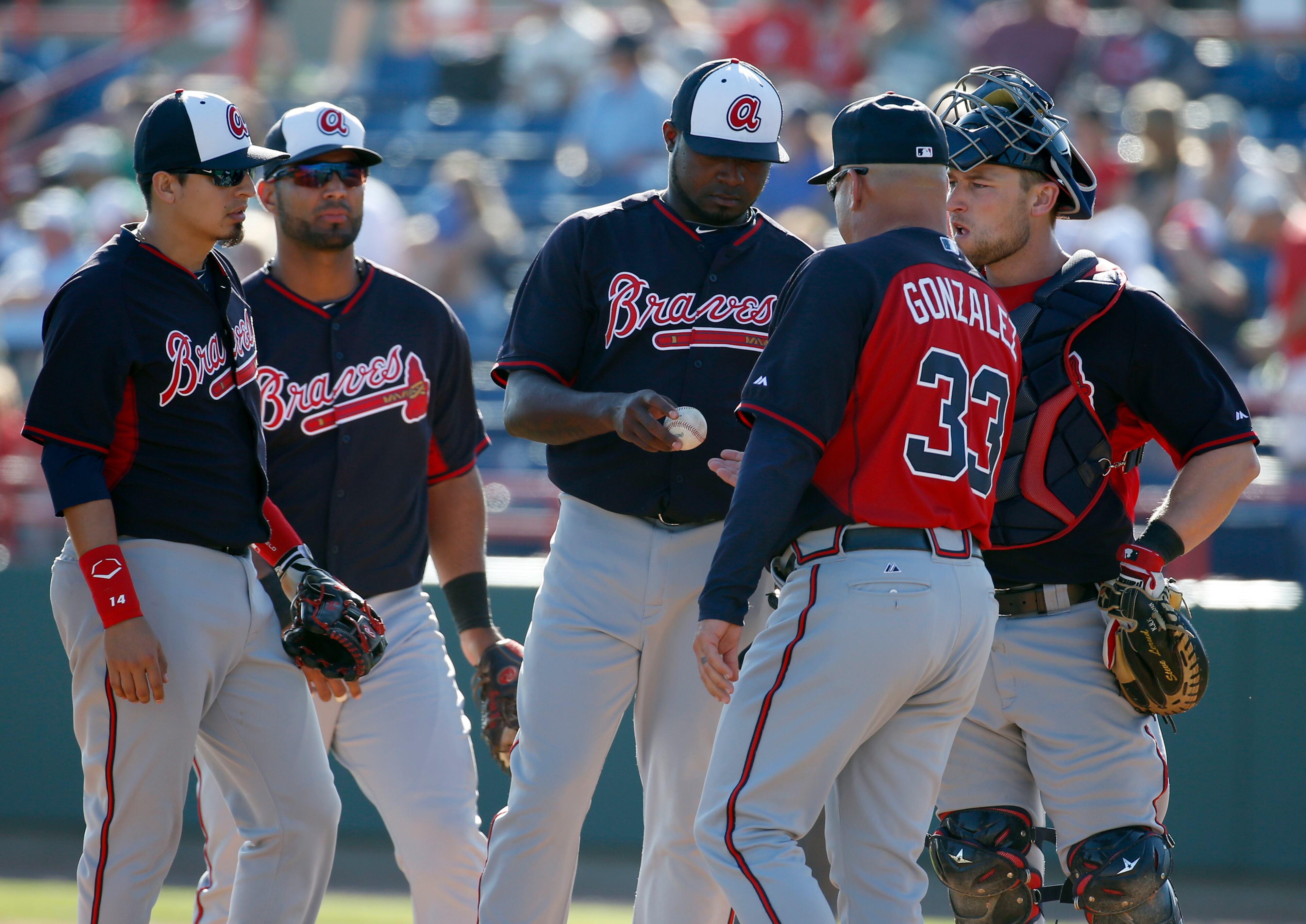 Atlanta Braves relief pitcher Wirfin Obispo (62) is relieved by manager Fredi Gonzalez (33) in a spring exhibition baseball game against the Washington Nationals, Saturday, March 1, 2014, in Viera, Fla. The Nationals won 16-15. (AP Photo/Alex Brandon)