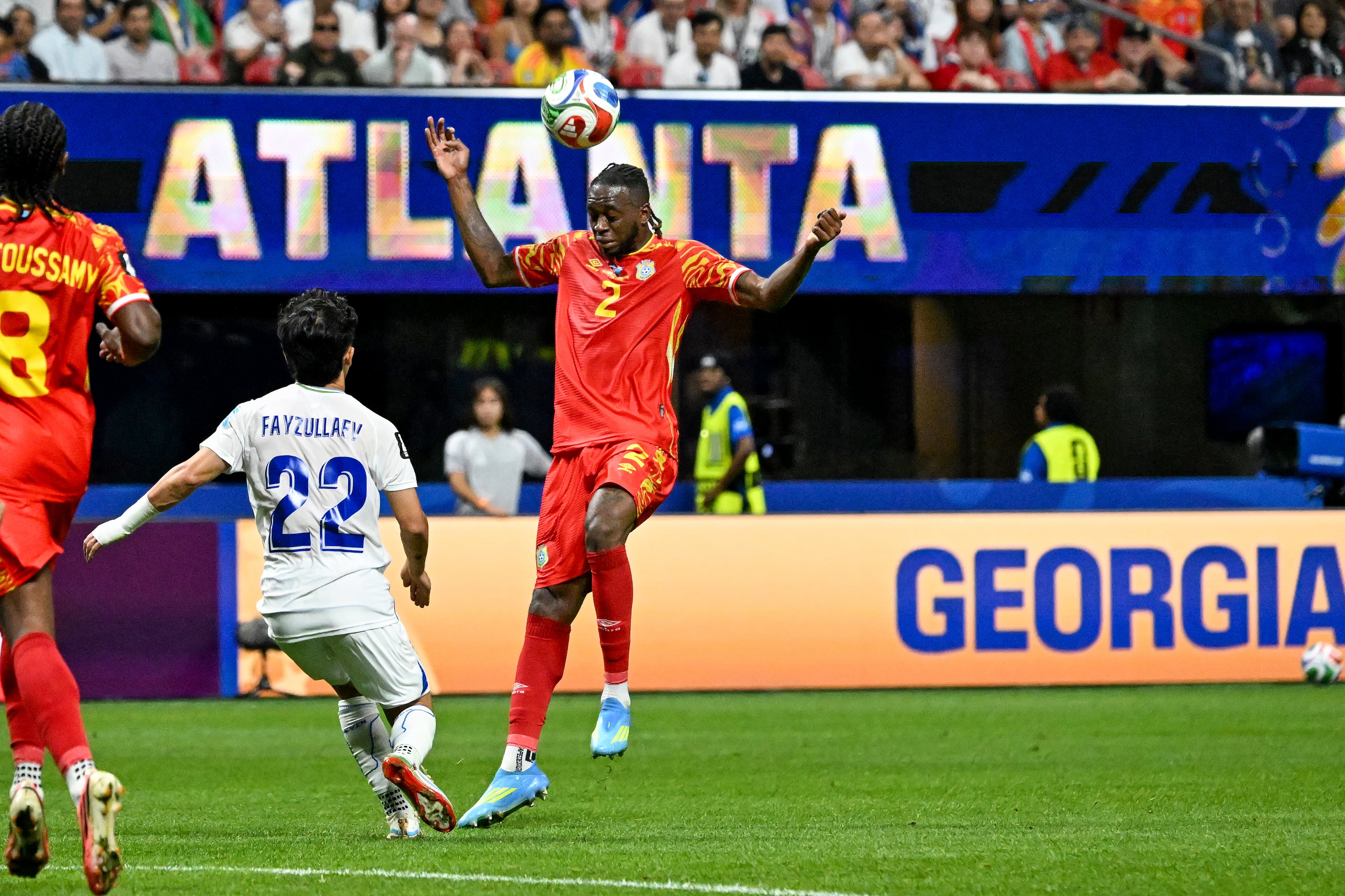 Uzbekistan midfielder Abbosbek Fayzullaev and Congo defender Aaron Wan-Bissaka (right) fight for the ball during the first half of a FIFA World Cup match at Atlanta Stadium (Mercedes-Benz Stadium) on Saturday, June 27, 2026, in Atlanta. (Hyosub Shin/AJC)