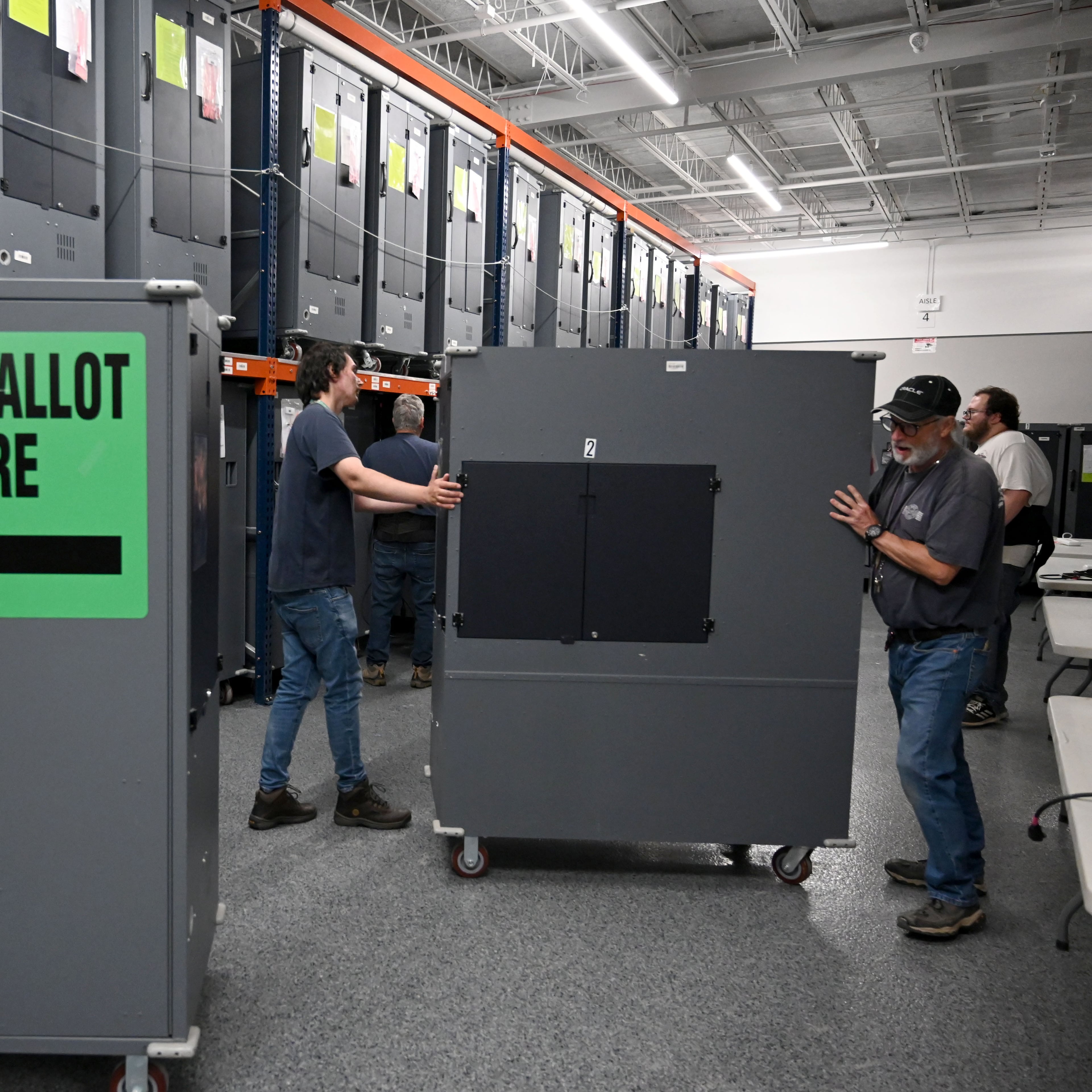 Election workers set up voting hubs before testing Ballot Marking Devices at the Cobb County Elections & Registration building on Tuesday, Sept. 22, 2026, in Marietta. Officials are testing voting touchscreens, ballot scanners and check-in tablets in the run-up to the midterms in an effort to find and mitigate problems before voting starts. (Hyosub Shin/AJC)
