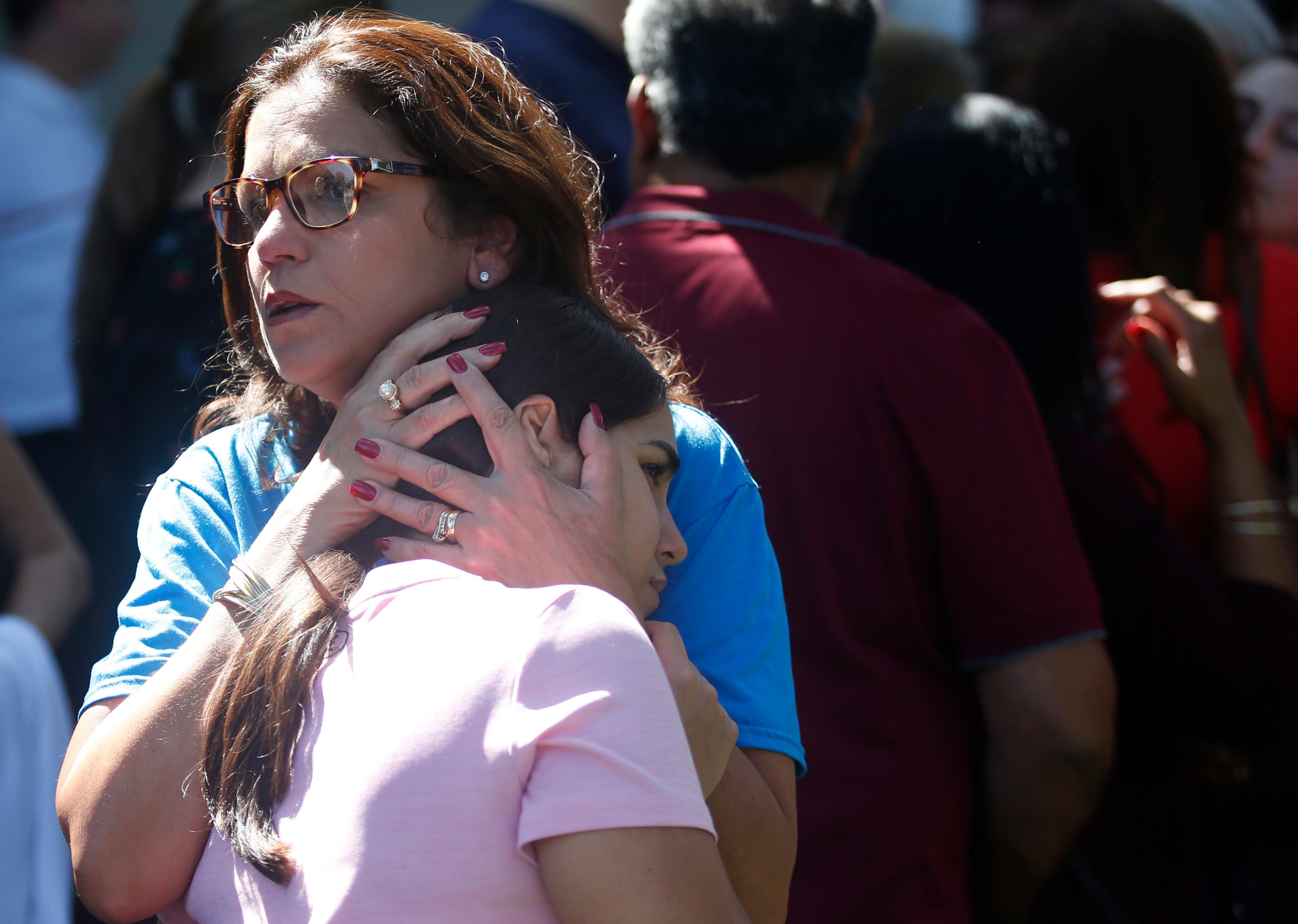 Attendees comfort each other at a prayer vigil for the victims of the shooting at Marjory Stoneman Douglas High School at the Parkland Baptist Church, Thursday, Feb. 15, 2018 in Parkland, Fla. Nikolas Cruz, a former student, was charged with 17 counts of premeditated murder Thursday morning. (AP Photo/Wilfredo Lee)
