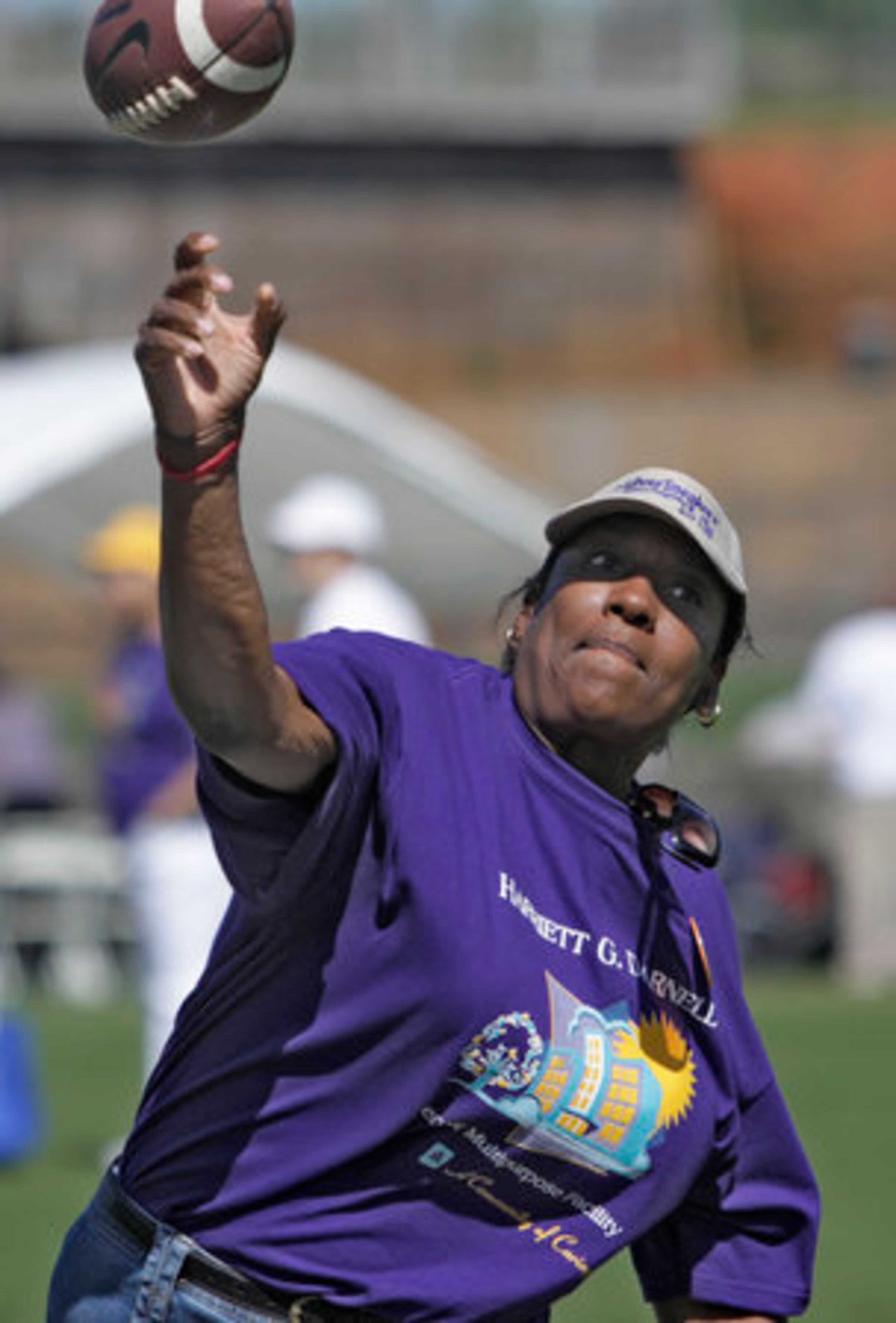 Sandra Alexander, 58, from Atlanta, competes in the football toss. More events take place throughout the month.