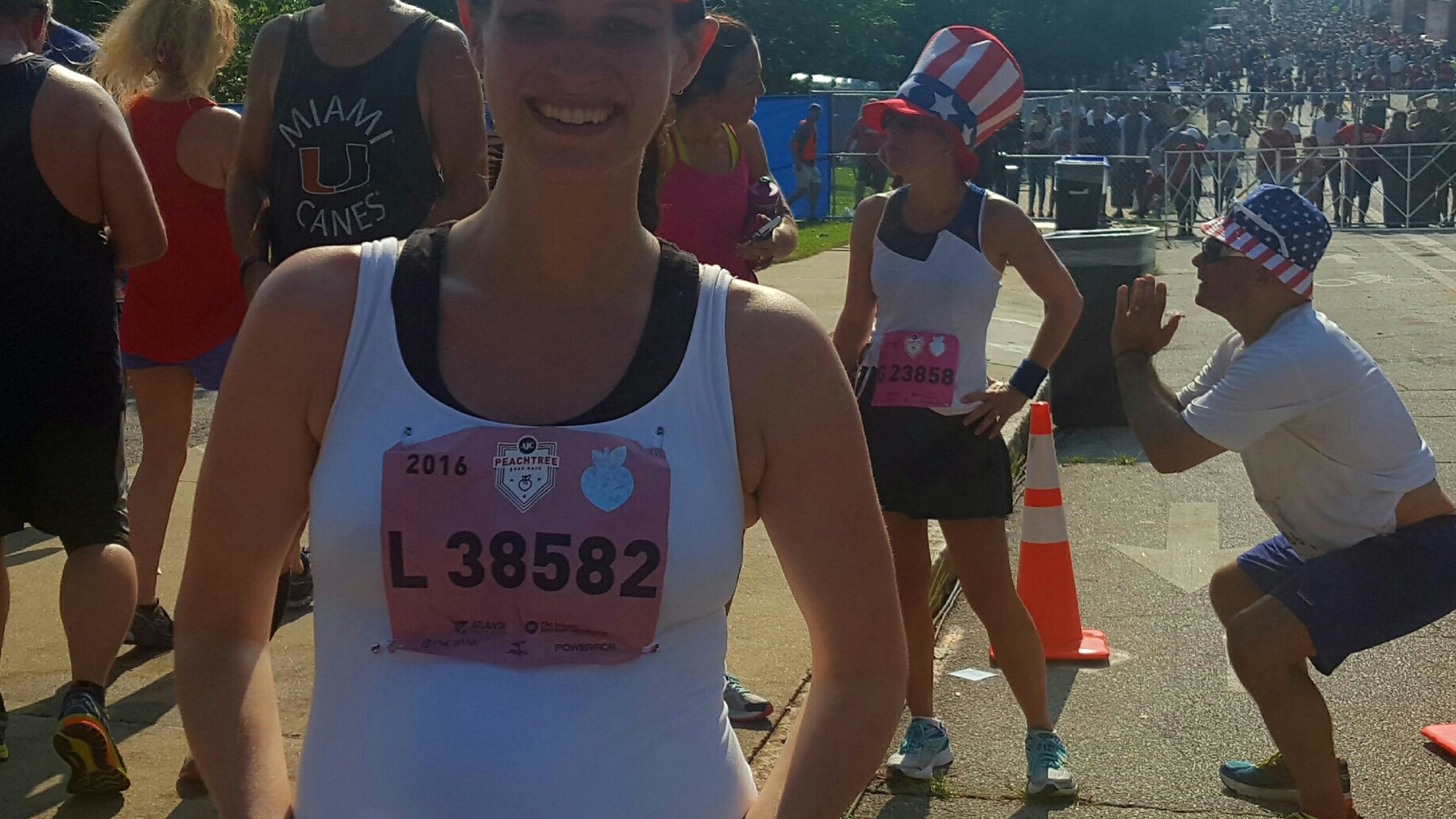 Sarah Bivens poses for a photo after running The Atlanta Journal-Constitution Peachtree Road Race while expecting child. (Jaylon Thompson/jaylon.thompson@ajc.com)