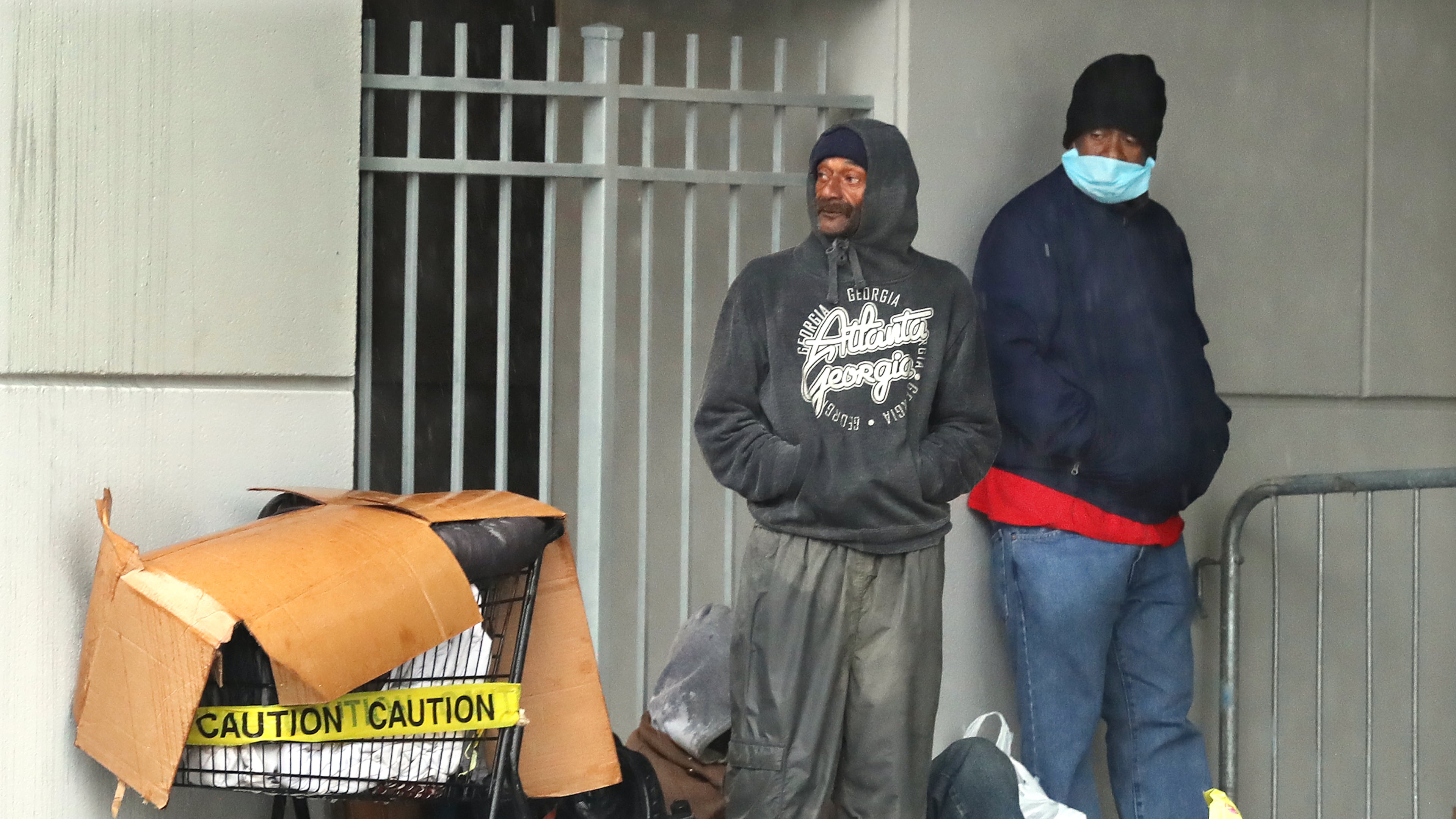 April 19, 2020 Atlanta: Homeless men seek shelter with their belongings near Atlanta City Hall while storms move through the area on Sunday, April 19, 2020, in Atlanta. Curtis Compton ccompton@ajc.com