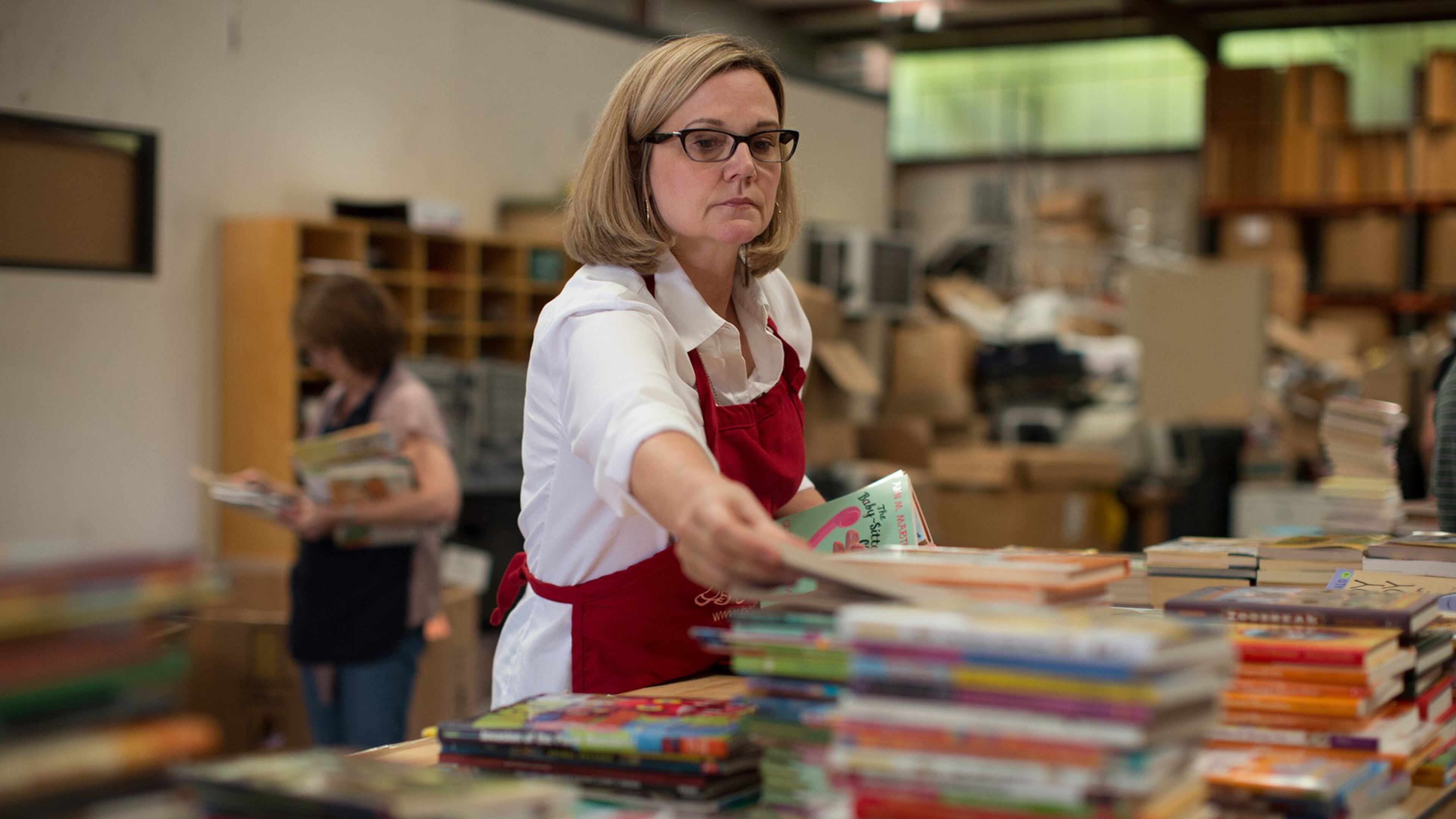 Melaney Smith sorts books in the Books for Keeps warehouse in Athens. Contributed by Books for Keeps.