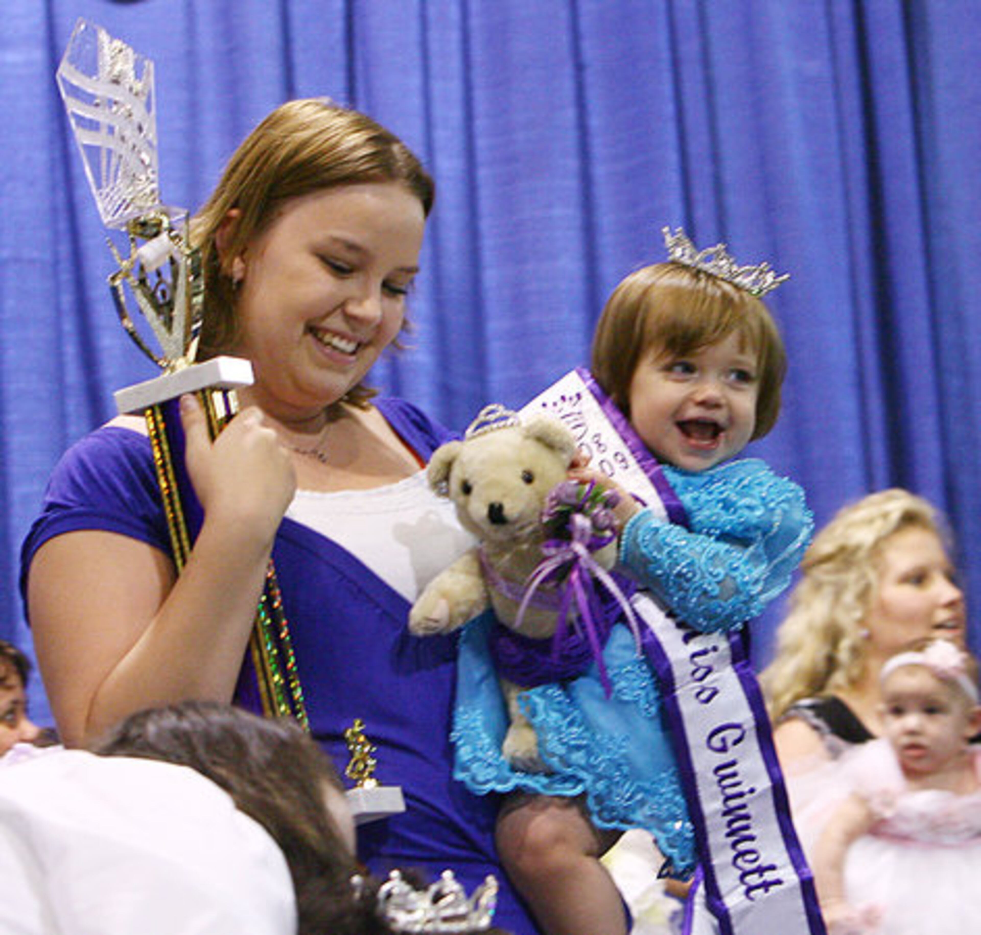 Jessica Moon holds her equally happy daughter Madilyn Moon, who is 2008 Baby Miss Gwinnett . The 14-month-old from Winder won the title Thursday at the Gwinnett County Fair.