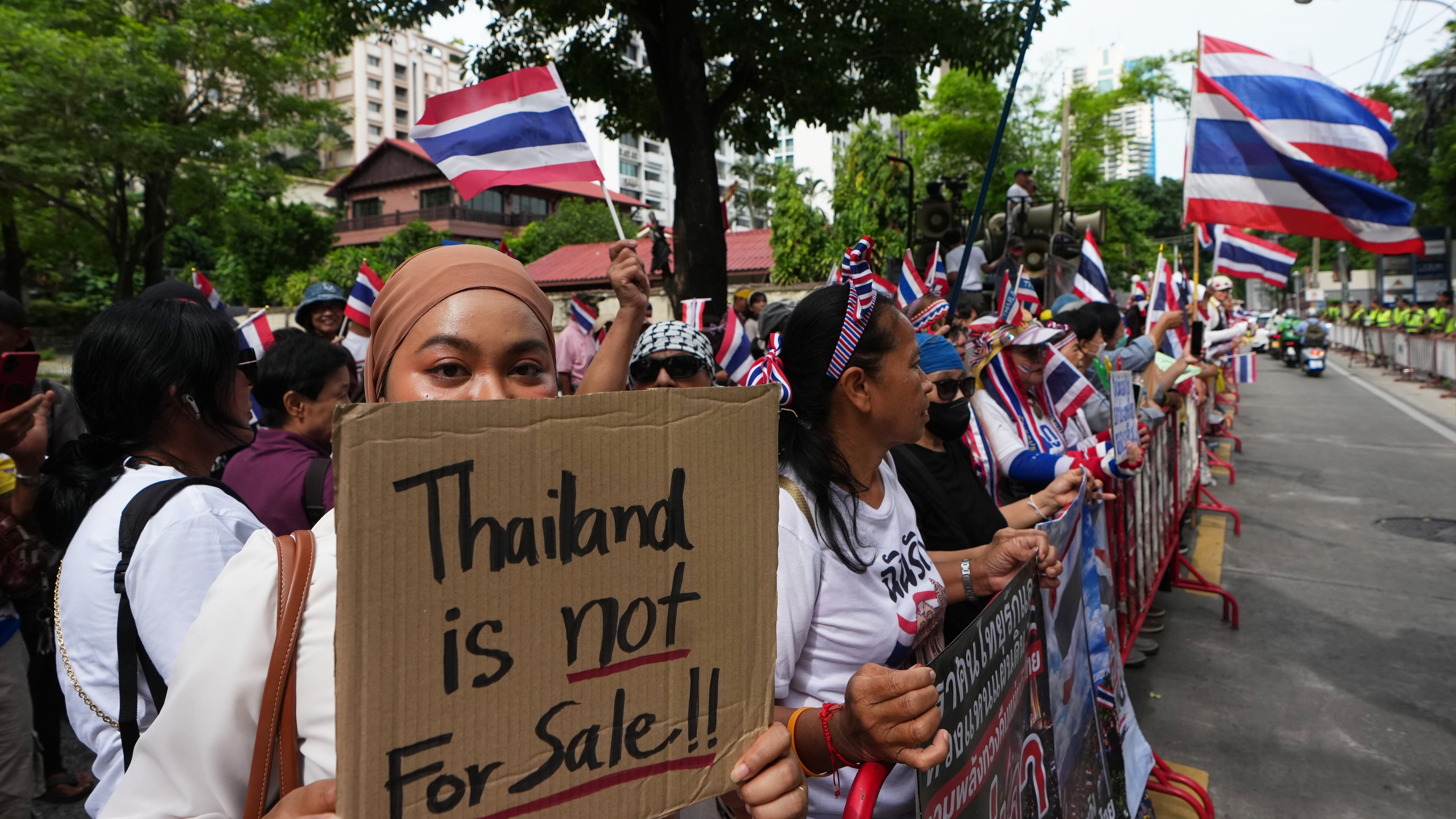 Protesters holding signs attend a demonstration demanding an end to alleged land-grabbing by foreigners, in front of Israeli Embassy in Bangkok, Thailand, Thursday, Sept. 10, 2026. (AP Photo/Sakchai Lalit)