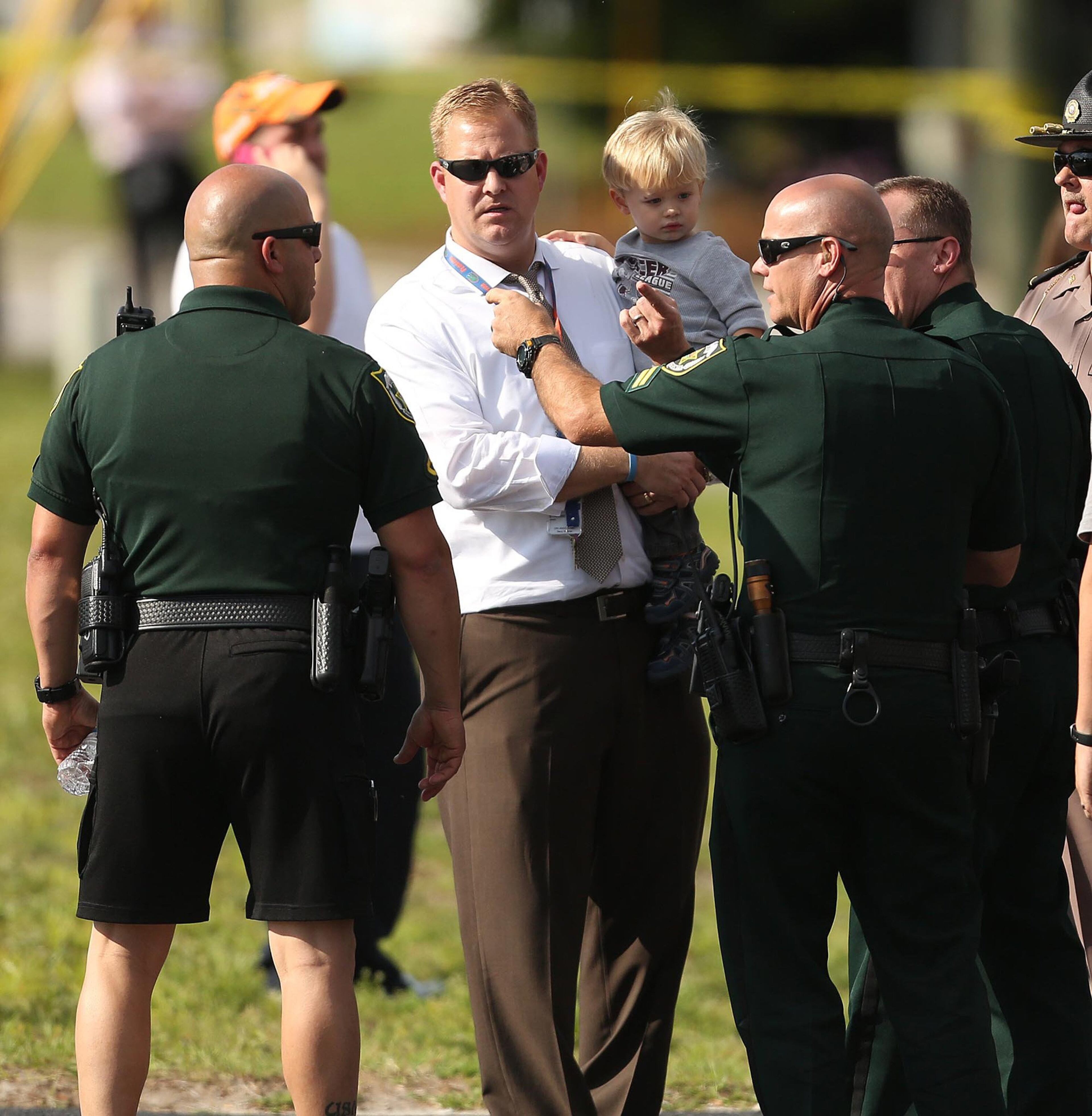 Children are escorted by their parents from the KinderCare Learning Center in Winter Park, Fla. (Stephen M. Dowell, Orlando Sentinel/MCT)