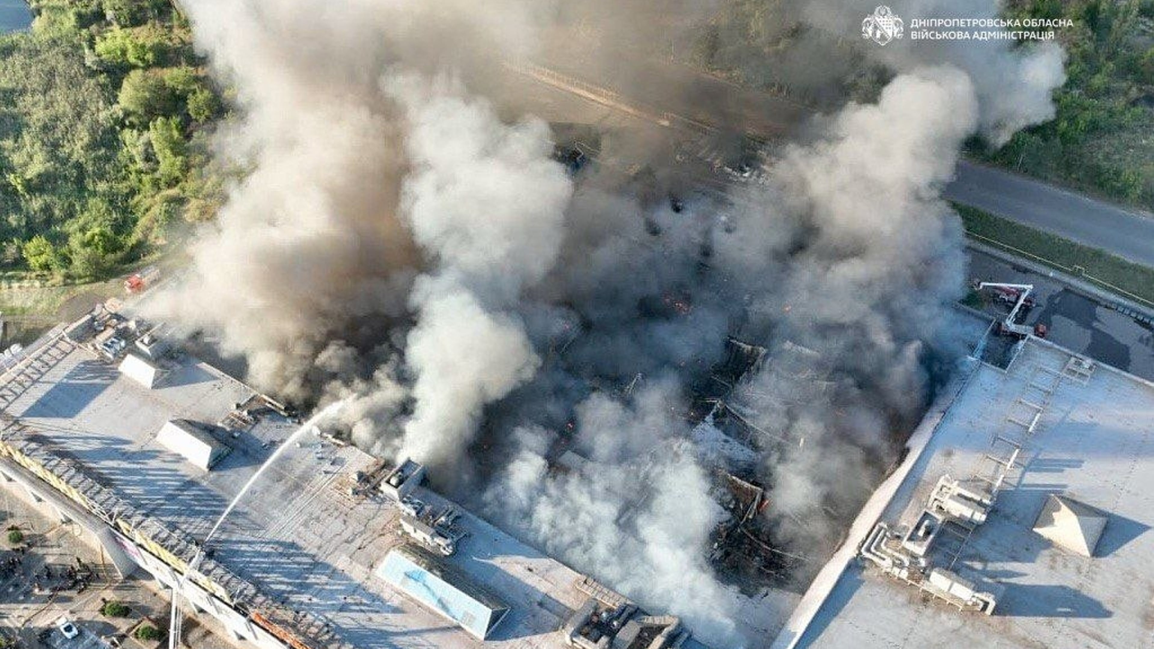 In this photo provided by the Ukrainian Military administration, firefighters work on a fire at a shopping mall following a Russian drone attack in Kryvyi Rih, Ukraine, Friday, Aug. 21, 2026. (Ukrainian Military administration via AP)